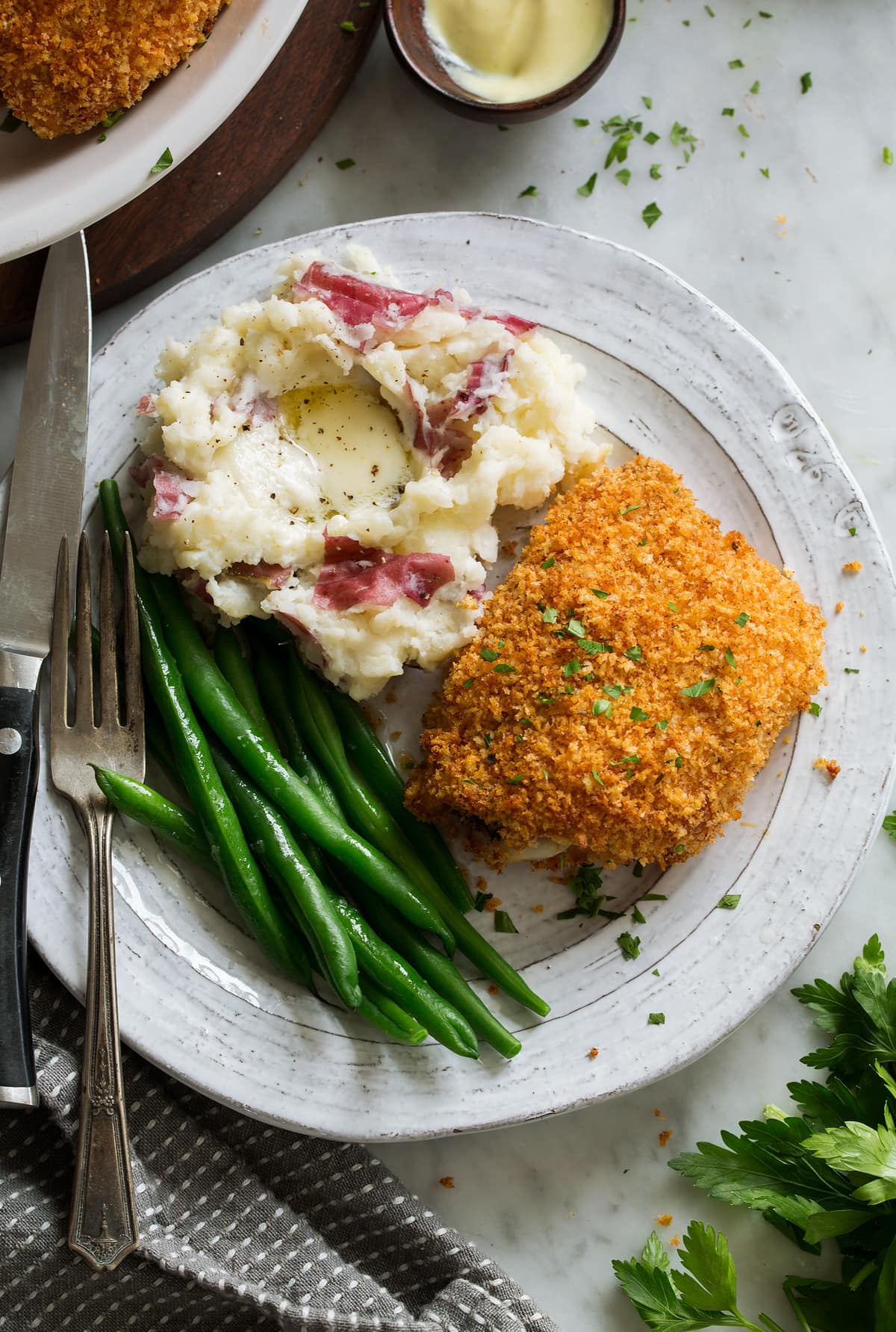 Oven Fried Chicken Oven Fried Chicken on serving plate with a side of mashed potatoes and green beans.