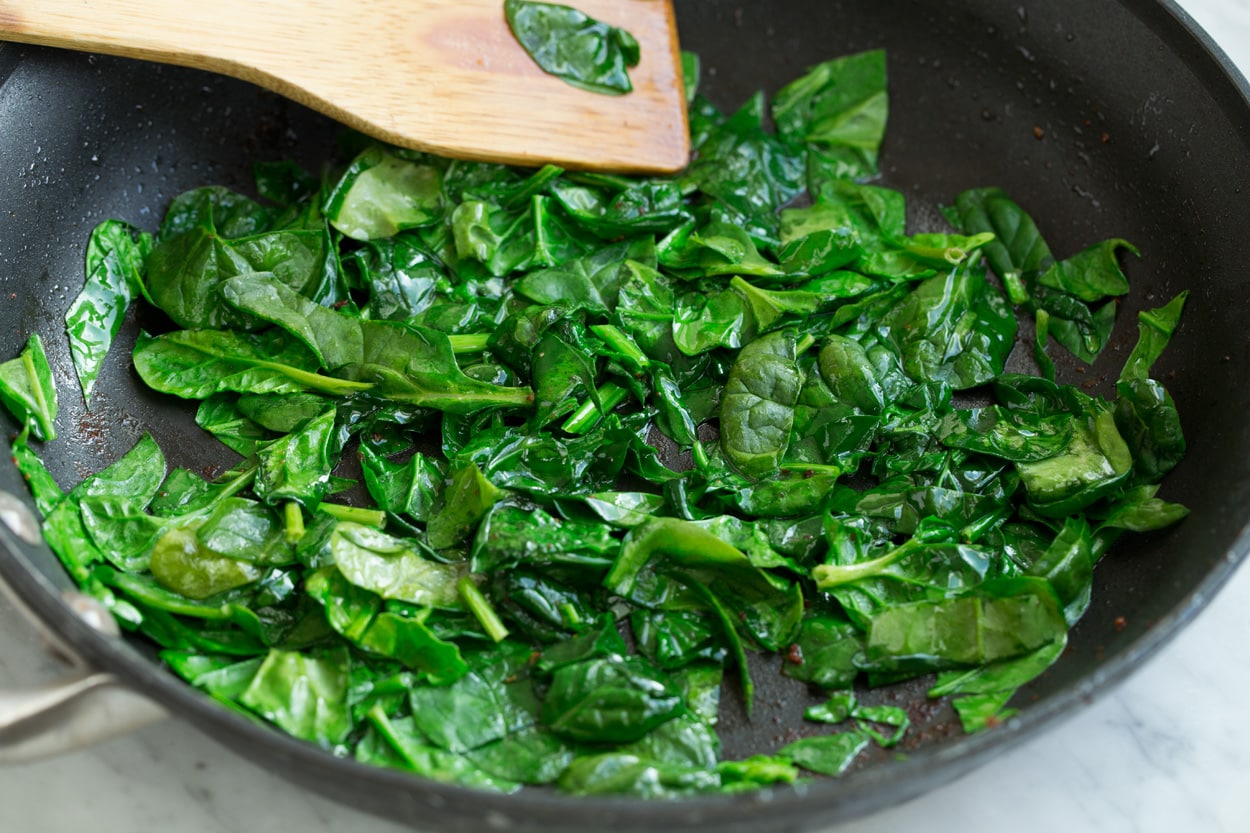 Frittata Recipe (Bacon, Spinach, Tomato and Swiss) Sauteeing spinach in a large skillet to add to frittata.