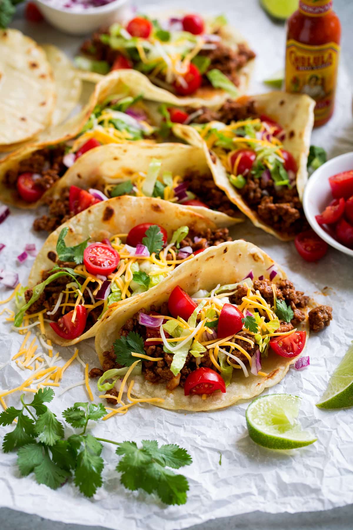 Ground Beef Tacos Meat tacos served with cheese, lettuce, tomatoes and Mexican hot sauce.