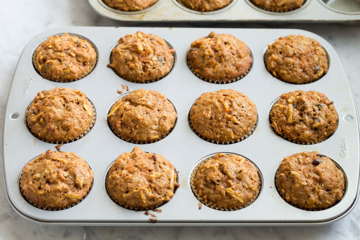 Morning Glory Muffins Morning glory muffins in a muffin pan after baking.