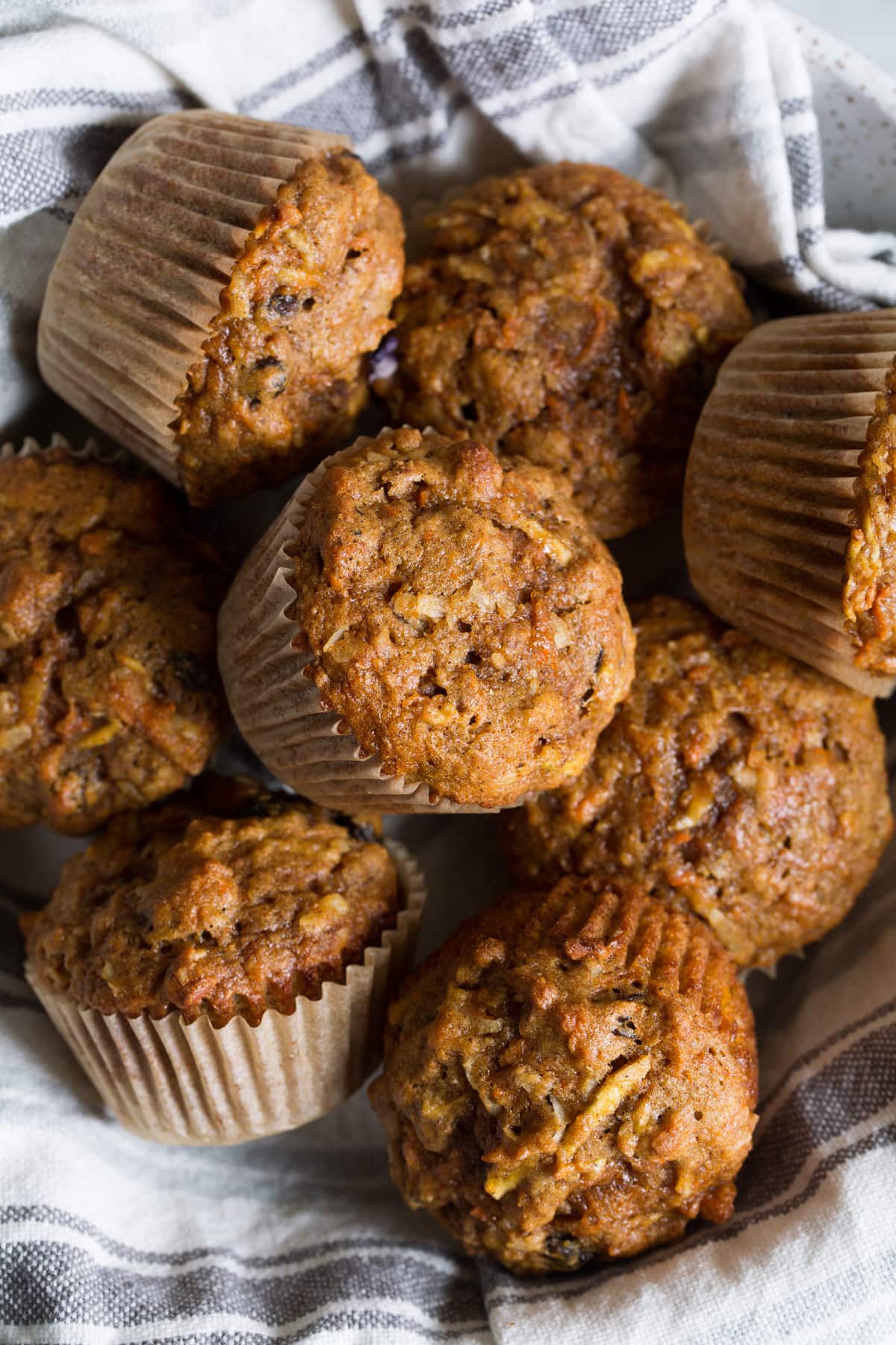 Morning Glory Muffins Morning glory muffins in a serving bowl with a kitchen towel.