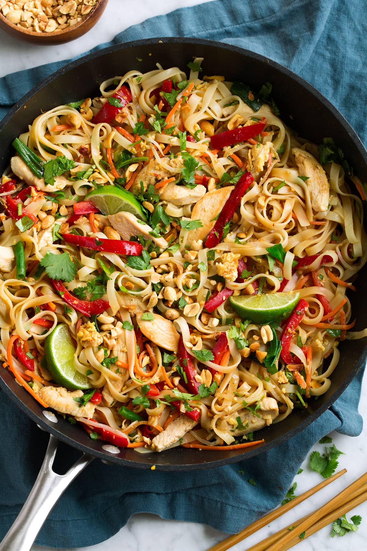 Pad Thai with Chicken or Shrimp Pad Thai in a black wok with chicken and fresh vegetables.