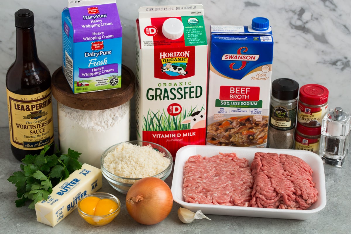 BEST Swedish Meatballs Recipe (Oven Baked)! Ingredients needed for Swedish meatballs shown here including milk, fresh bread crumbs, spices, ground beef and pork, onion, garlic, butter, egg yolks, parsley, beef broth, milk, cream, flour and Worcestershire sauce.