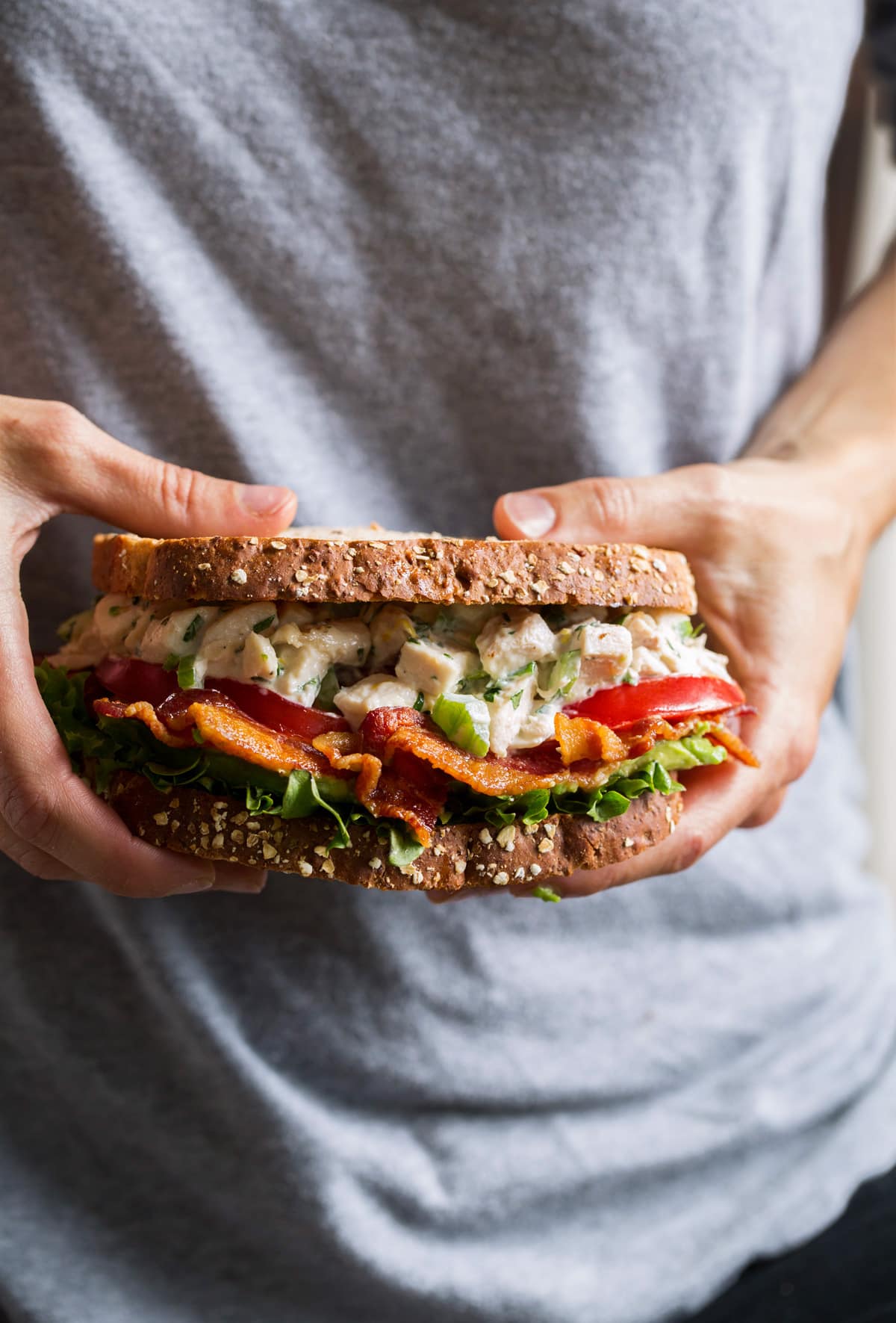 Chicken Salad Sandwich Person holding chicken salad sandwich