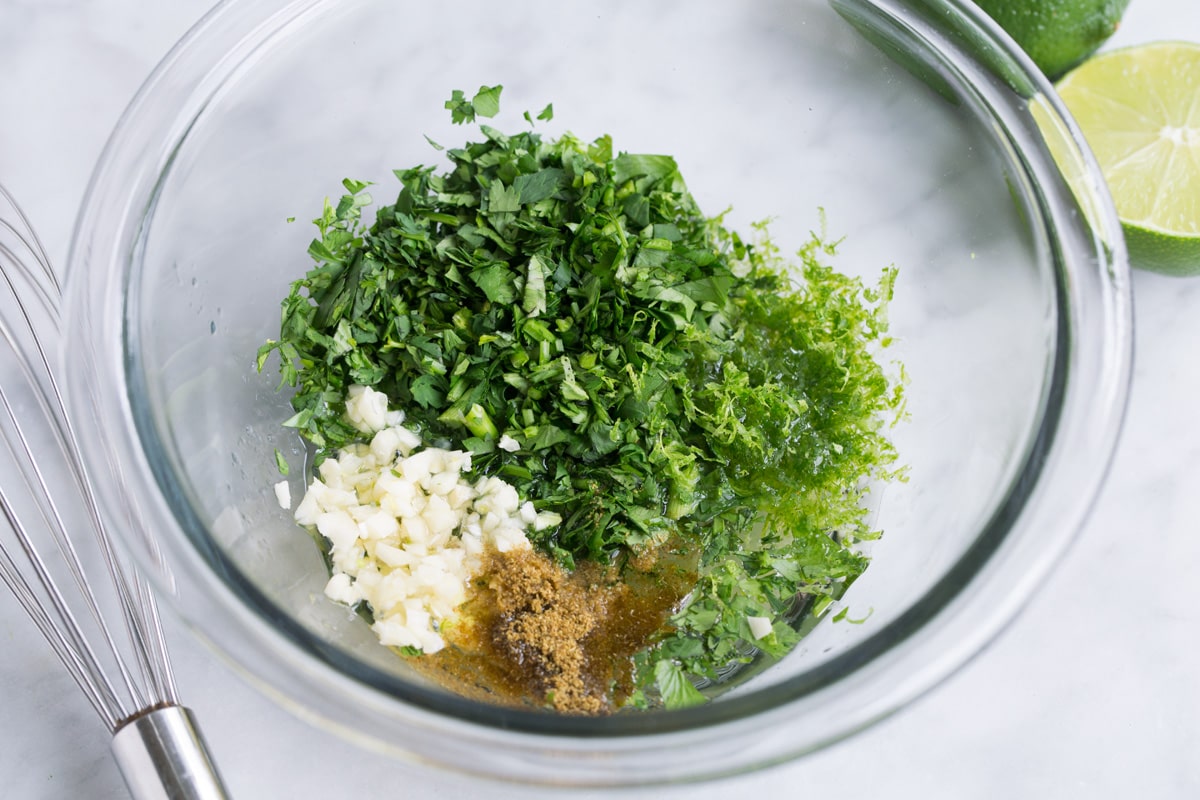 Rice dressing ingredients in a glass mixing bowl.