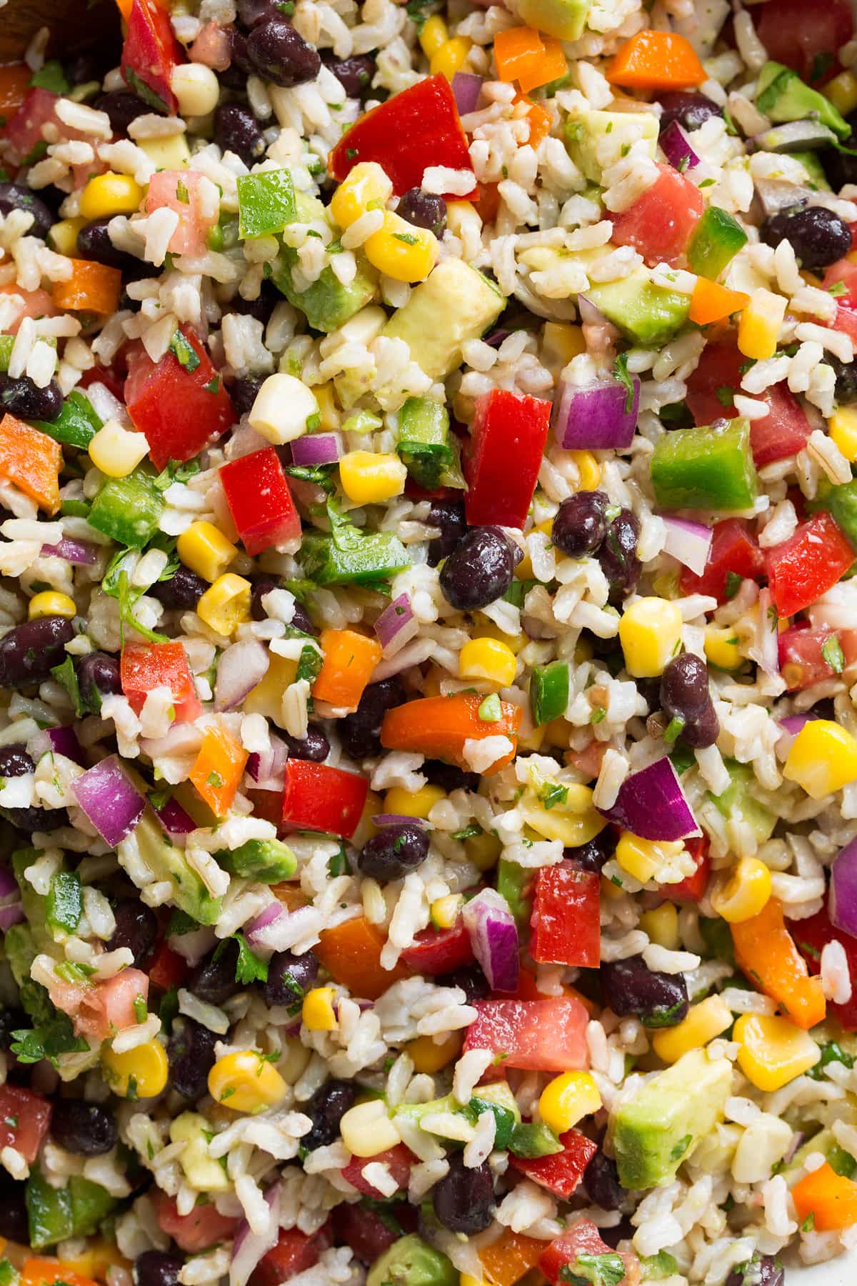 Fiesta Rice Close up image of rice with colorful vegetables and black beans.