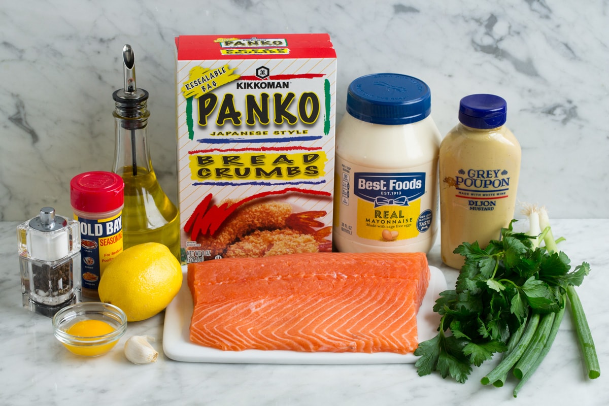Crispy Salmon Patties (made with fresh salmon, not canned!) Ingredients needed to make salmon patties including mayonnaise, dijon mustard, panko, olive oil, green onions, parsley, salmon, lemon, egg yolk, garlic, old bay seasoning, salt and pepper.