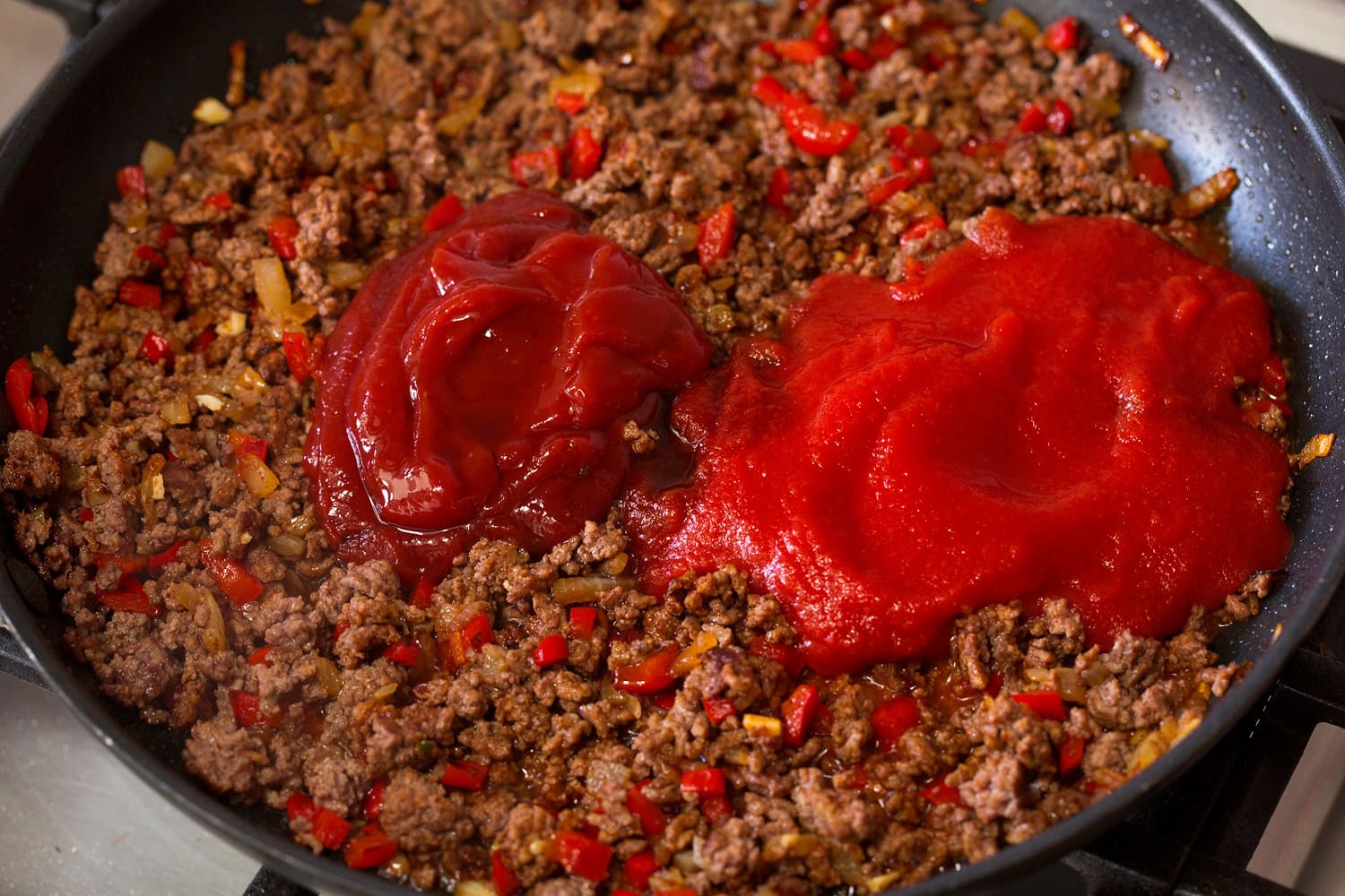Sloppy Joes Tomato sauce and ketchup added to beef mixture.