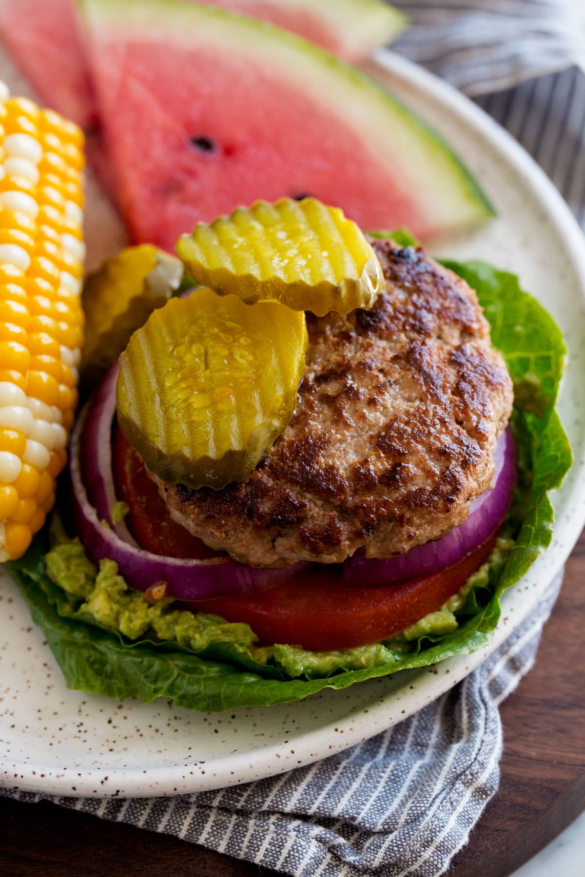 Turkey Burgers Low carb open faced turkey burger on lettuce leaves. Served with a side of corn and watermelon.