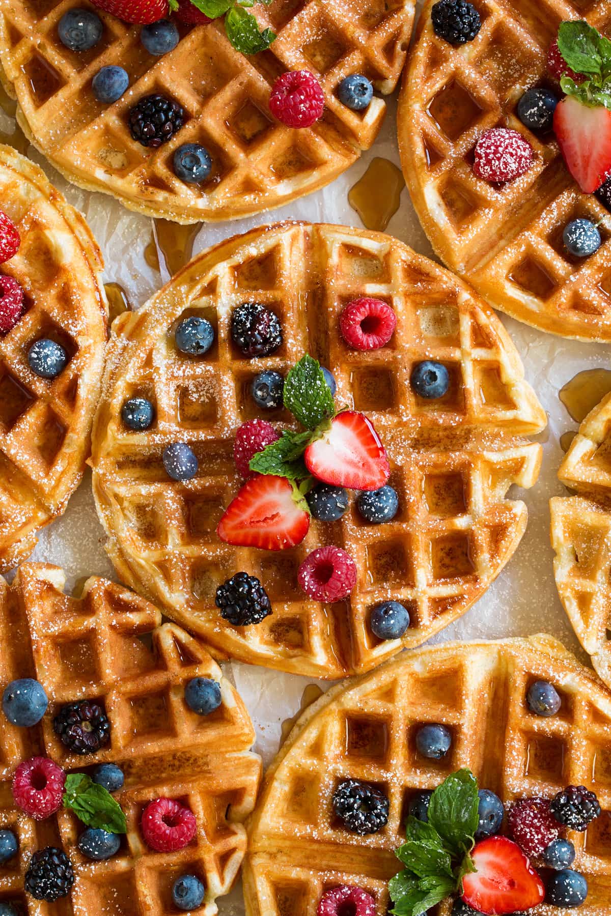 Belgian Waffles - these turn out perfect every time! Light, fluffy and tender on the inside and crisp and golden on the outside. A family favorite recipe! #belgian #waffles #breakfast Close up image of Belgian waffles.