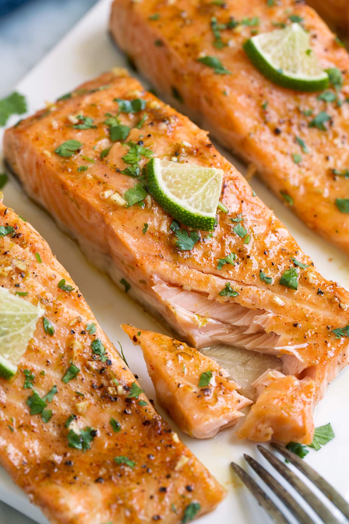 Brown Sugar Lime Baked Salmon Salmon fillet with one pieces missing to show texture of interior.
