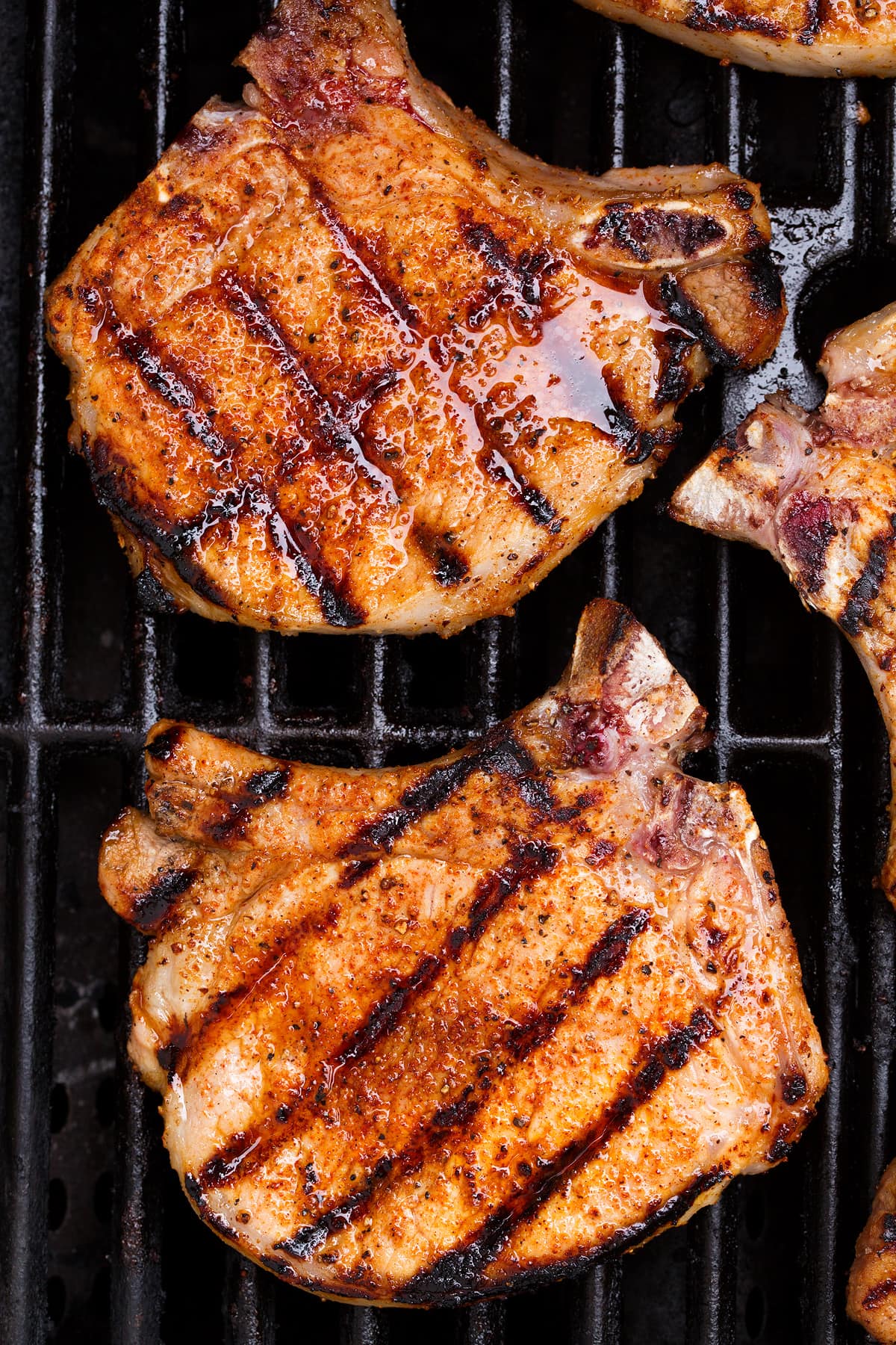 Grilled Pork Chops Overhead close up image of two pork chops on a grill.