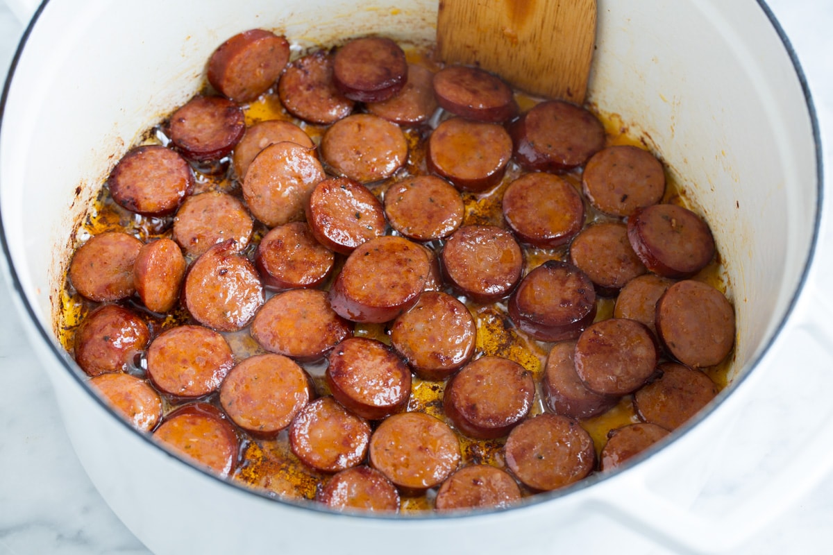 Perfect Red Beans and Rice - delicious Louisiana style comfort food at it's best! #redbeans #rice #southern #recipe #dinner Browning smoked sausage in a pot.