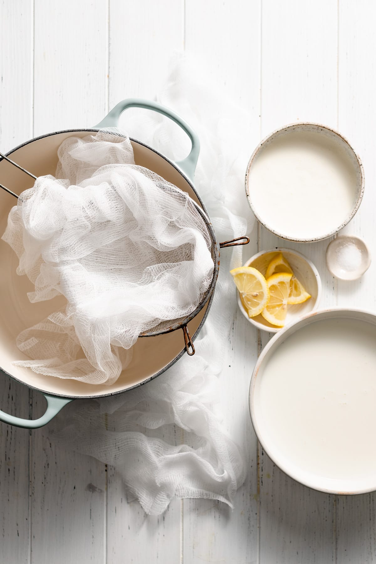 Homemade Ricotta Cheese - the BEST ricotta you'll try! It's so much better than store bought and incredibly easy to make! It's delicious in savory and sweet dishes and you can use the leftovers for toast. #ricotta #cheese #recipe #homemade #italianrecipes Ingredients and equipment needed to make ricotta cheese shown here.