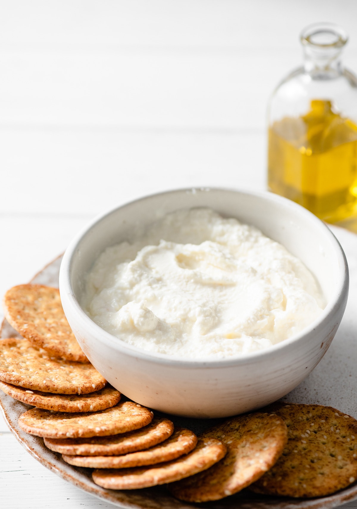 Homemade Ricotta Cheese - the BEST ricotta you'll try! It's so much better than store bought and incredibly easy to make! It's delicious in savory and sweet dishes and you can use the leftovers for toast. #ricotta #cheese #recipe #homemade #italianrecipes Bowl full of plain ricotta cheese.