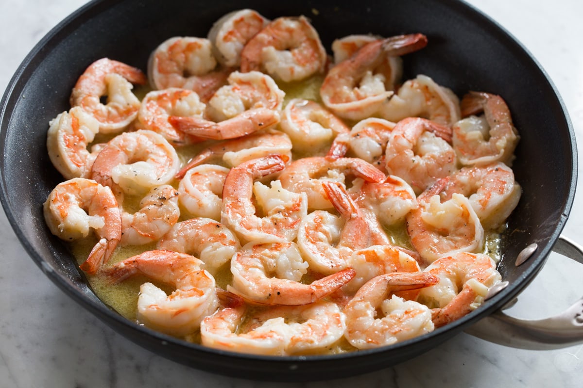 Shrimp Scampi - shrimp are seared in an incredibly flavorful buttery wine sauce and tossed with pasta for the perfect, unforgettable dinner! Everyone will go crazy over this! #shrimp #scampi #pasta #garlic #dinner #recipe Cooked shrimp in sauce.