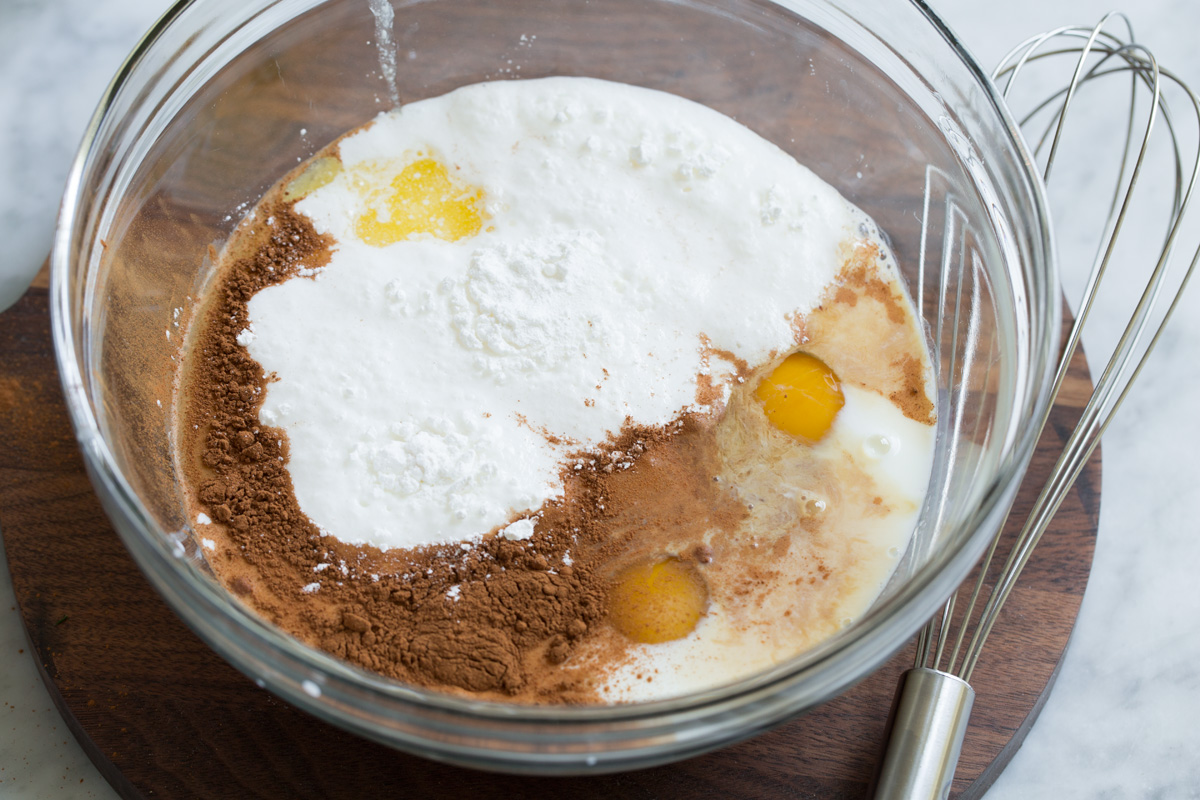 Baked Oatmeal Mixing liquid ingredients in a glass bowl for baked oatmeal.