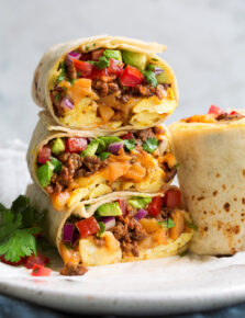 Stack of breakfast burritos.
