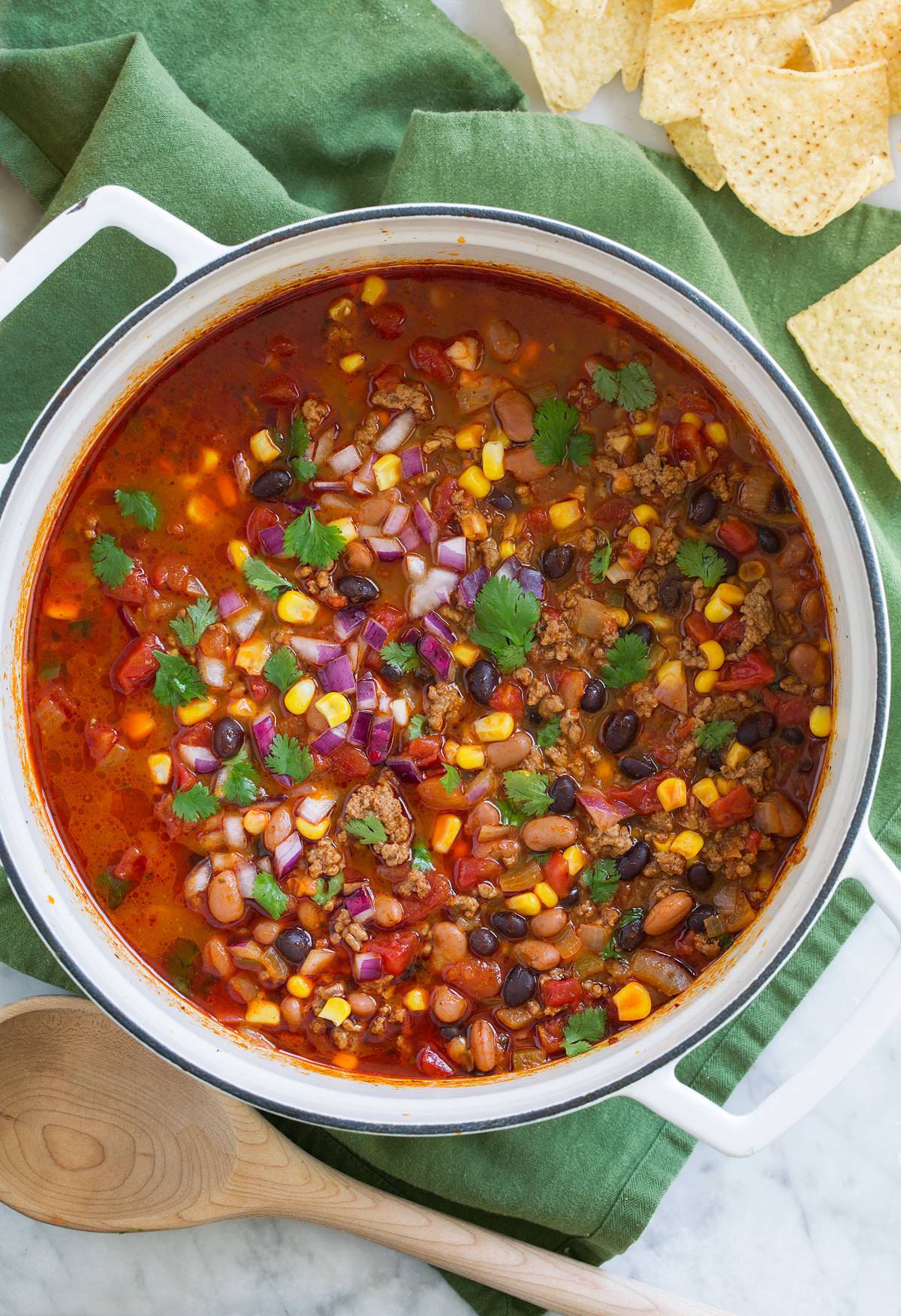 Taco Soup - easy, incredibly tasty soup! Loaded with hearty ingredients and brimming with delicious seasoned flavor. Perfect for cold fall and winter days! #tacosoup #soup #fall #recipe Overhead image of pot full of easy taco soup.