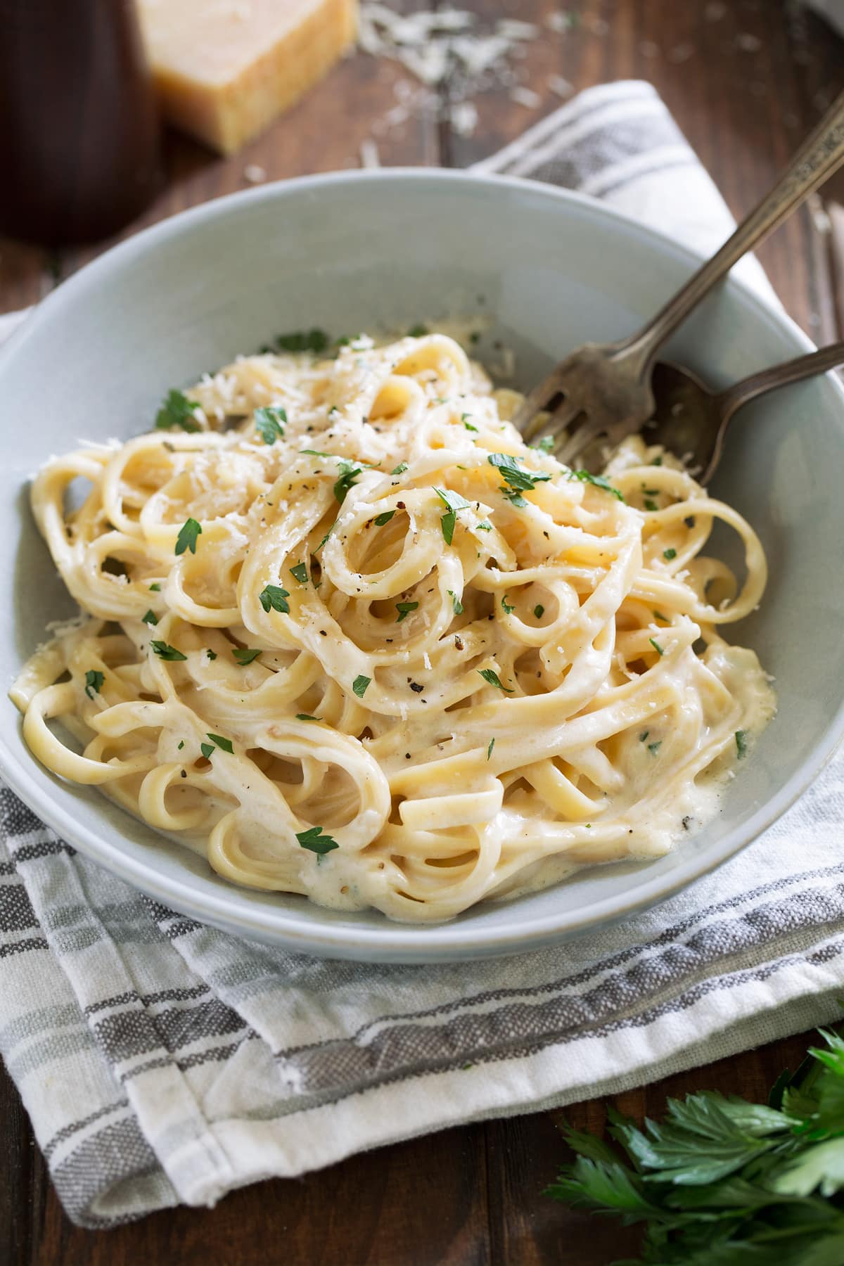 Best Alfredo Sauce - made with half milk and half cream so it's not too heavy, and includes plenty of parmesan for incredible flavor! So easy and seriously delicious! #alfredosauce #alfredo #fettuccinealfredo #dinner #pasta Bowl of fettuccine pasta with alfredo sauce.