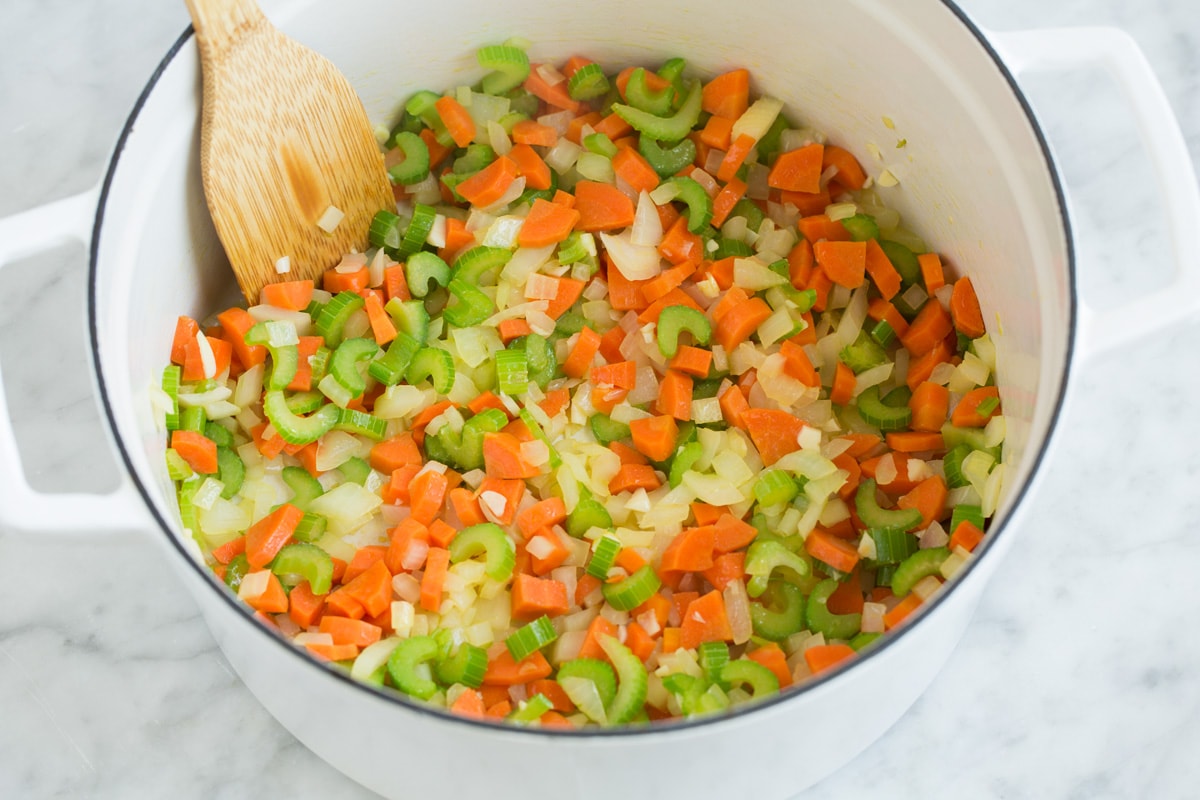 The BEST Quick and Easy Chicken Noodle Soup! This has been my go-to recipe for years. So easy and everyone always loves it! #chickennoodle #soup #dinner #chicken Sauteing carrots, celery, onion and garlic in a pot.