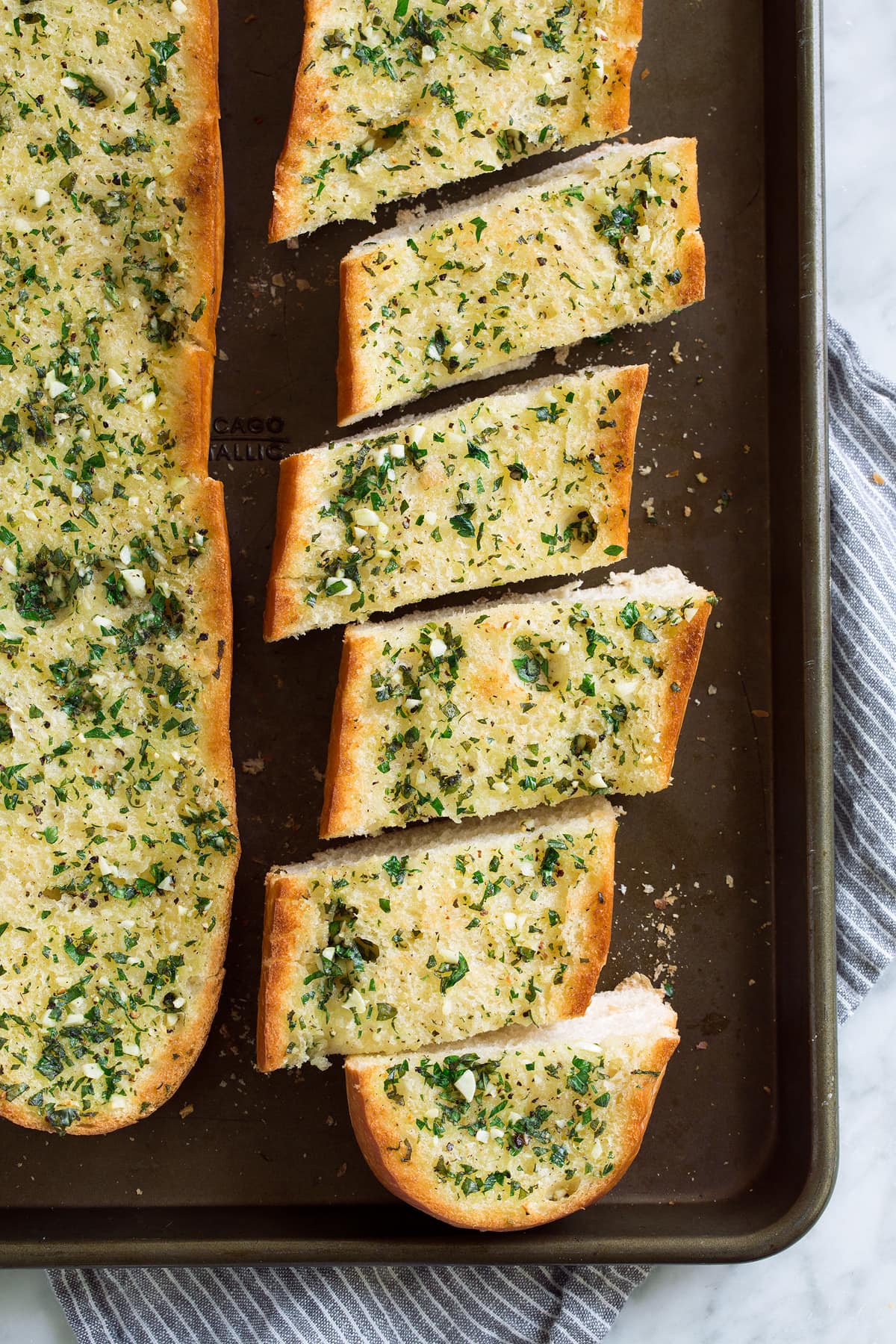 Then serve it with a soup or an all out comfort food pasta dinner! Loaf of garlic bread cut into slices on a baking sheet.
