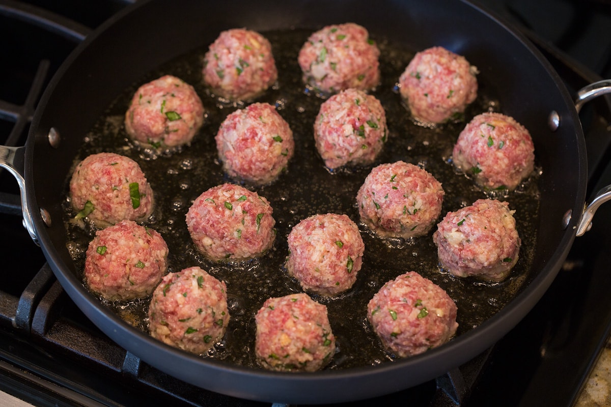 BEST MEATBALLS - these are so flavorful, so tender and packed with fresh ingredients! Makes the best spaghetti and meatballs ever! #meatballs #spaghetti #italian #dinner #groundbeef #pork #recipe fried meatball recipe in skillet