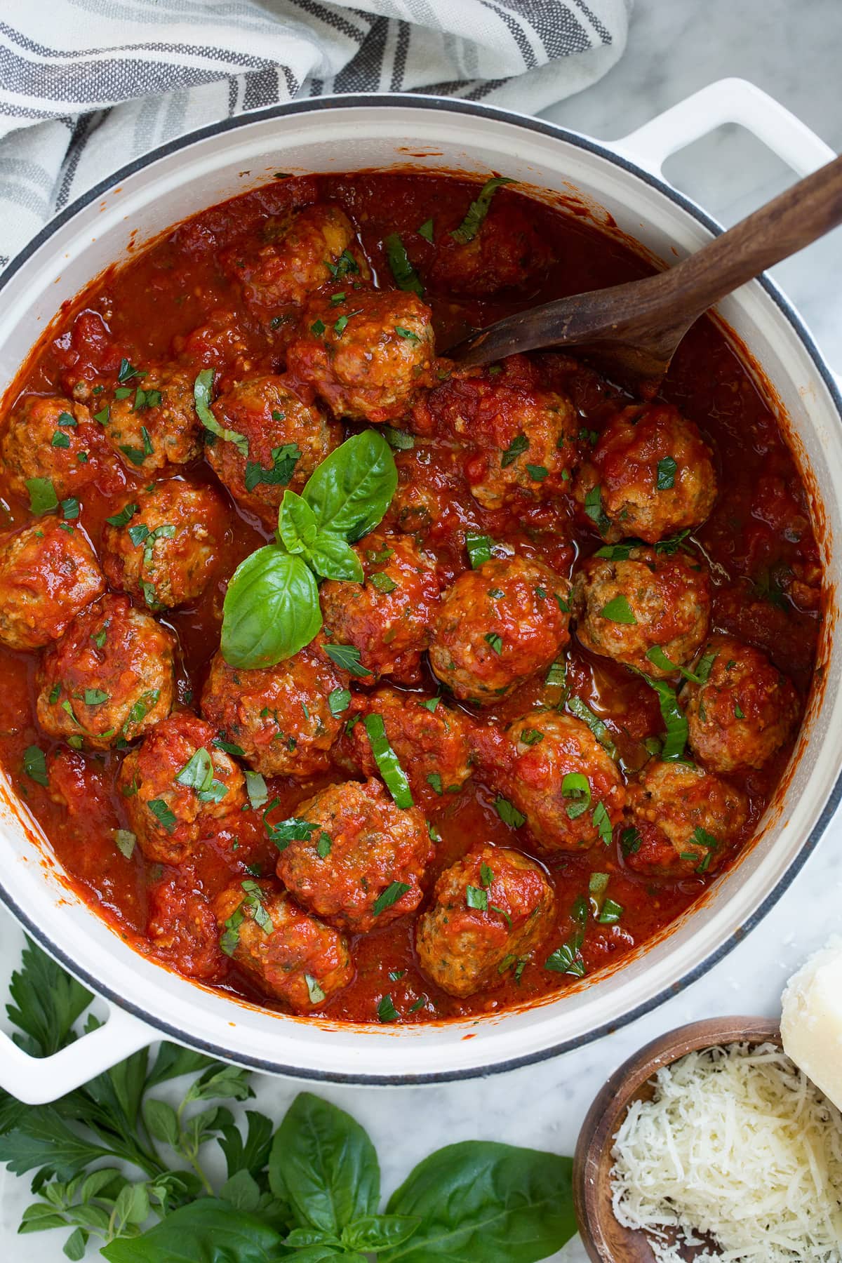 BEST MEATBALLS - these are so flavorful, so tender and packed with fresh ingredients! Makes the best spaghetti and meatballs ever! #meatballs #spaghetti #italian #dinner #groundbeef #pork #recipe Pot full of meatballs and marinara sauce.