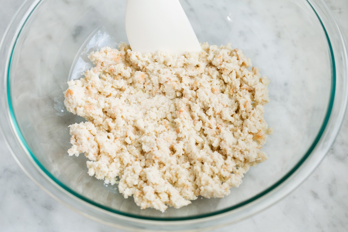 BEST MEATBALLS - these are so flavorful, so tender and packed with fresh ingredients! Makes the best spaghetti and meatballs ever! #meatballs #spaghetti #italian #dinner #groundbeef #pork #recipe Mixing bread and milk mixture in a glass bowl.