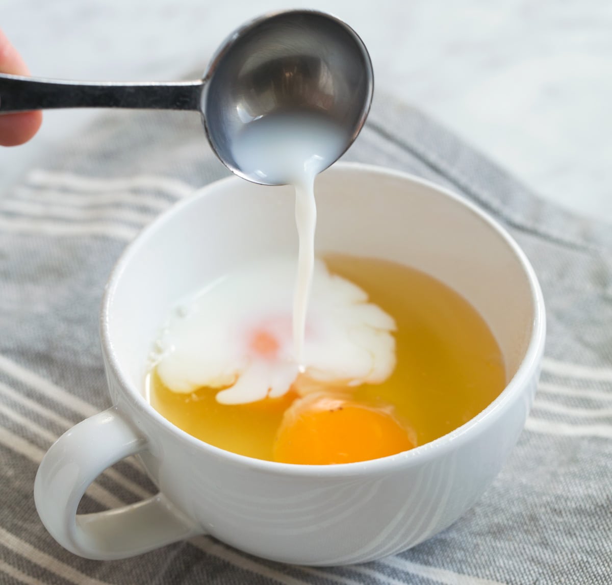 Microwave Eggs Adding Milk to eggs in cup