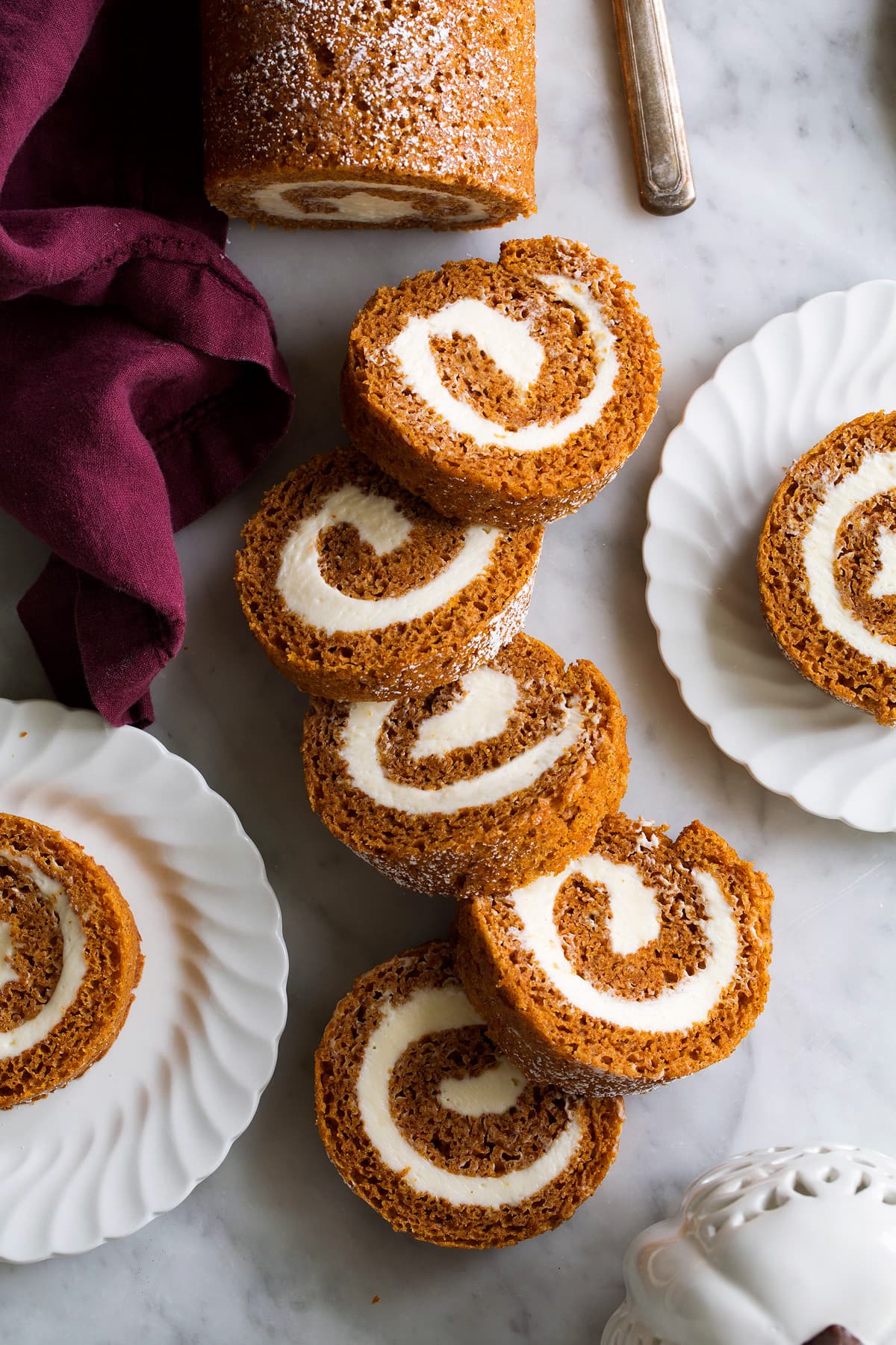 Pumpkin Roll Sliced pumpkin roll on a marble surface.