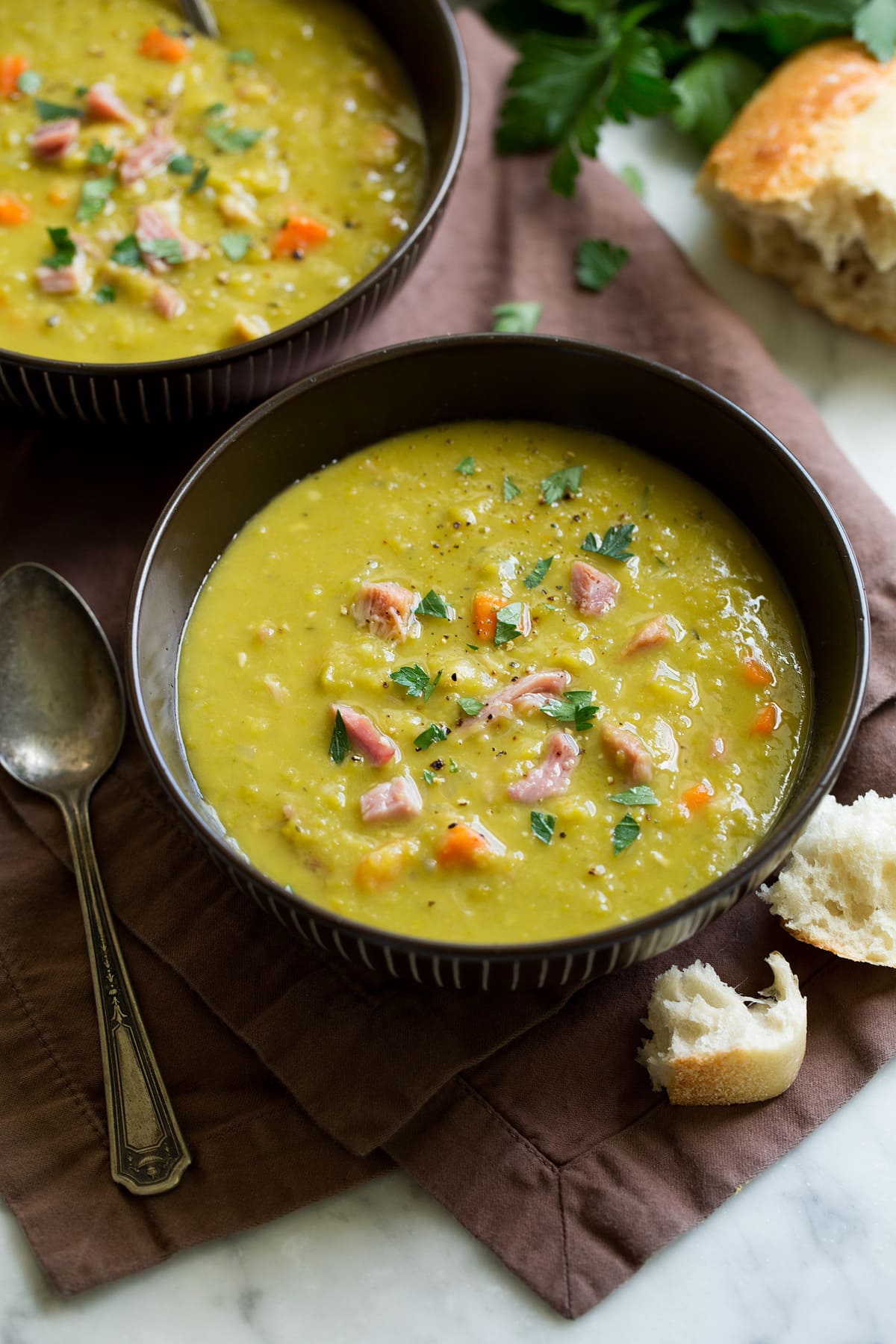 Split Pea Soup - such a delicious and comforting soup. This made from scratch version is a hundred times better than what you get in the can and it's so easy to make! #splitpea #soup #recipe Split pea soup in a serving bowl.