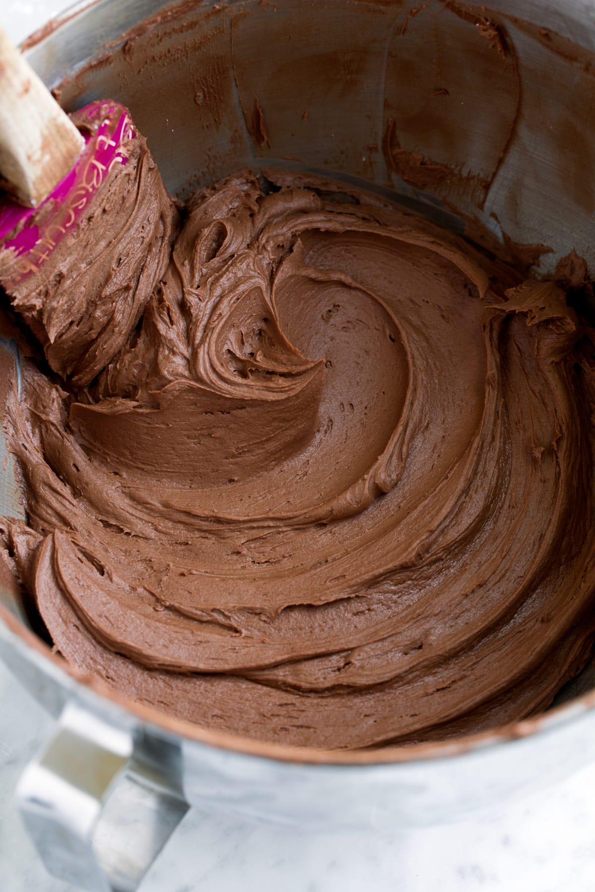 BEST Chocolate Buttercream Frosting - rich, creamy, fluffy, smooth and perfectly decadent! #chocolate #buttercream #frosting #cake Chocolate Buttercream Frosting in a mixing bowl.