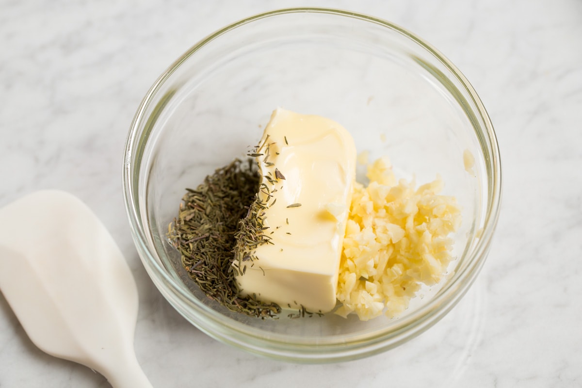 How to Cook Turkey Making butter garlic herb mixture in a glass mixing bowl.