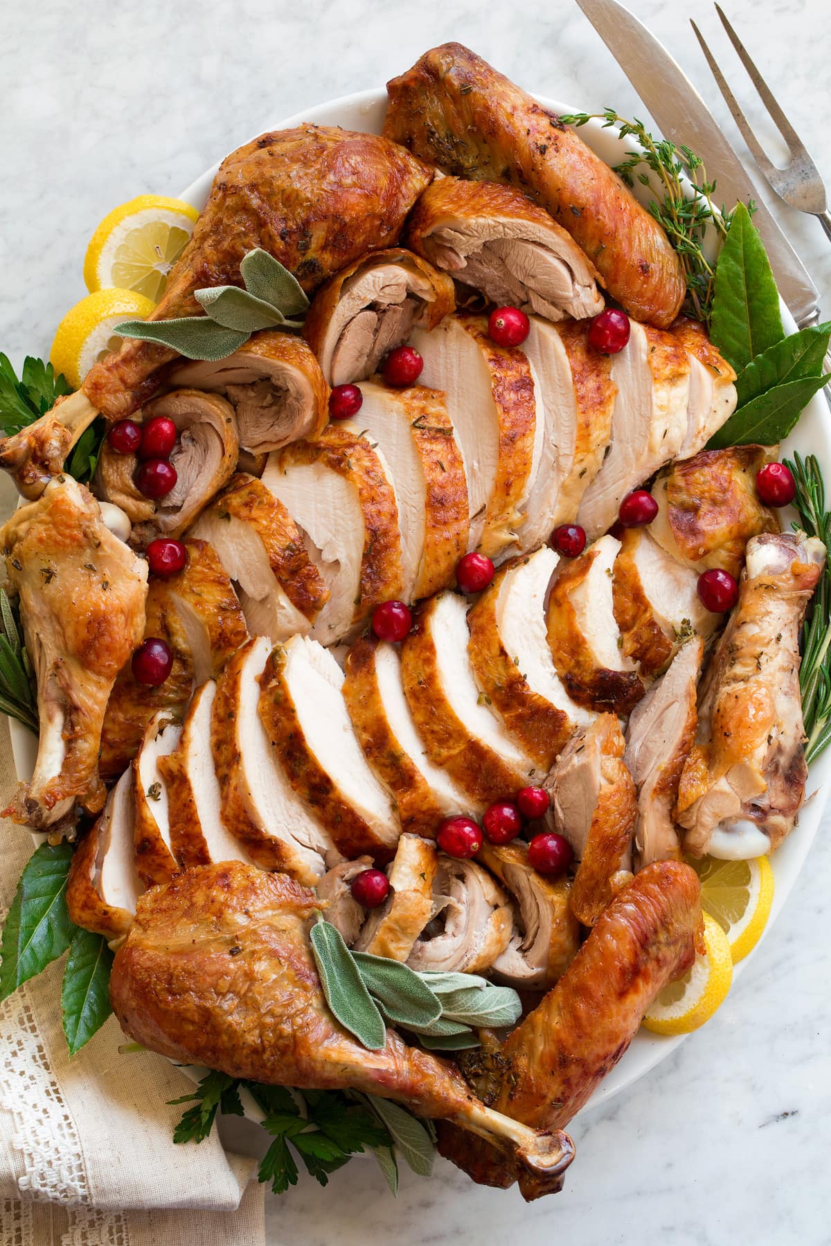 Roast Turkey - easy to follow recipe that turns out tender, juicy and full of flavor! A holiday staple! #turkey #thanksigiving Carved turkey on a platter.