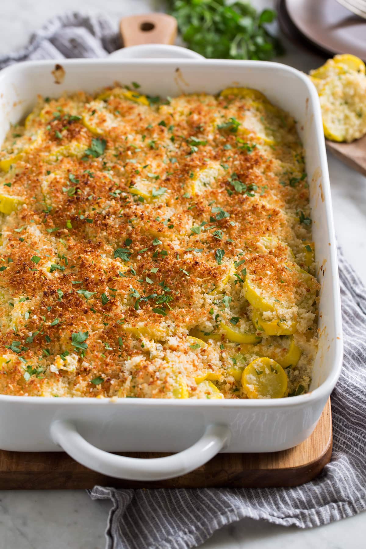 Squash Casserole Baked yellow Squash Casserole in a white ceramic baking dish.