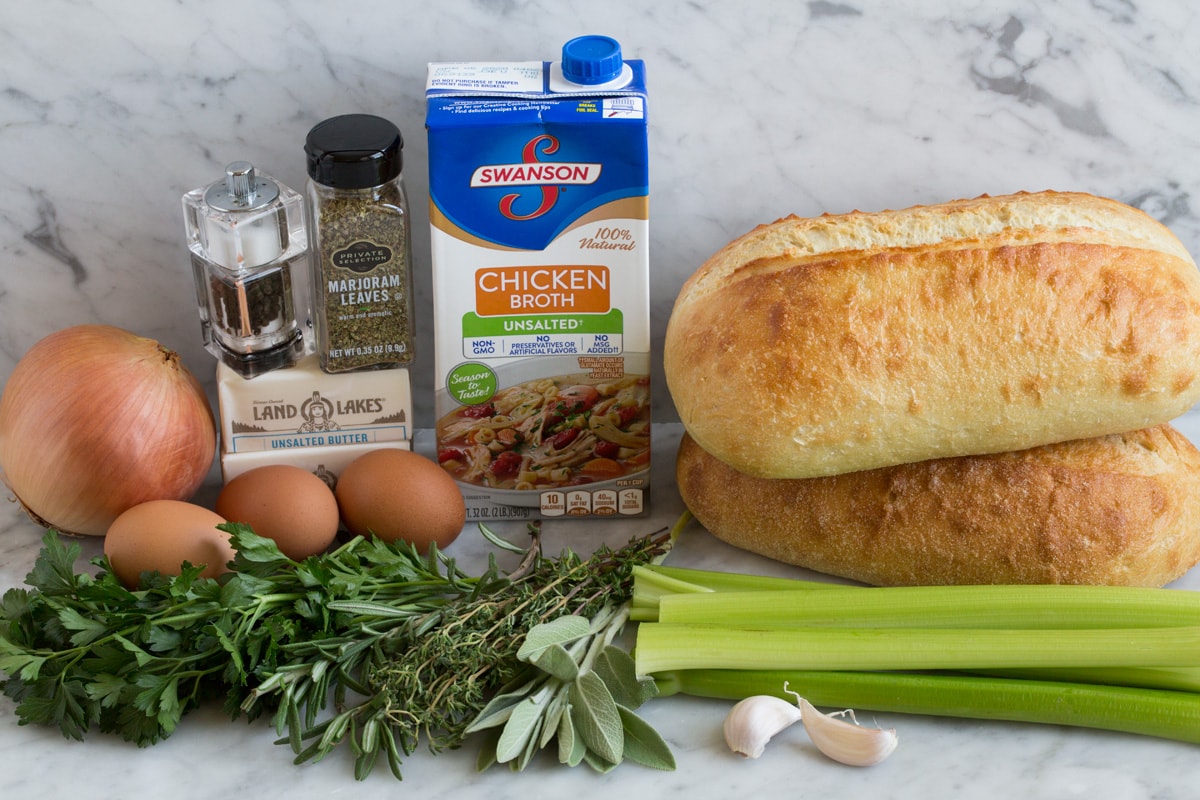 Stuffing Recipe - this is my FAVORITE stuffing! It's perfectly moistened in the center, browned and crisp on the edges and packed with butter and herb flavor. A fall staple! #stuffing #thanksgiving #sidedish #recipe Ingredients needed to make stuffing from scratch shown here.