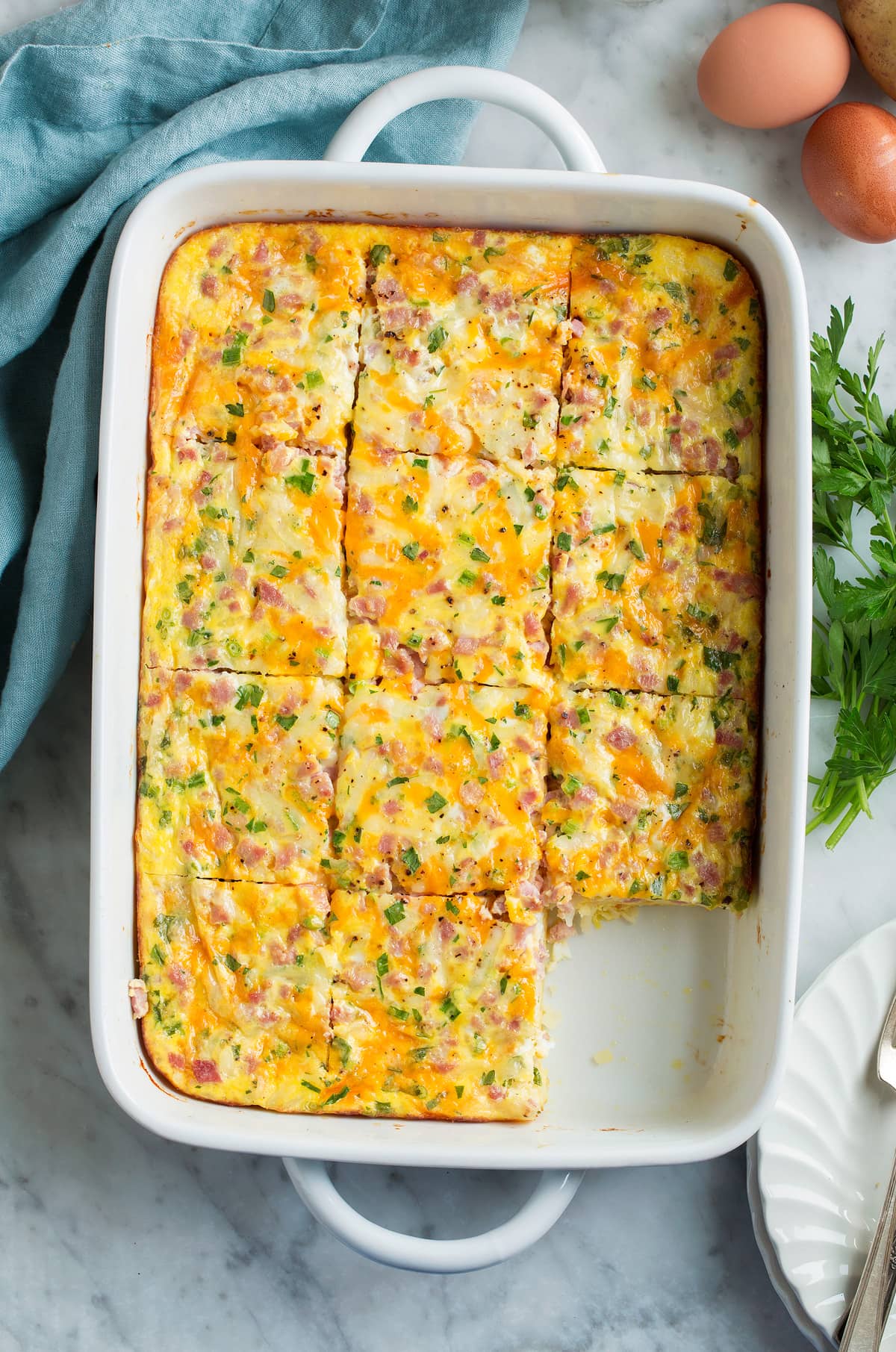 Breakfast Casserole Overhead image of breakfast casserole in a baking dish cut into slices.