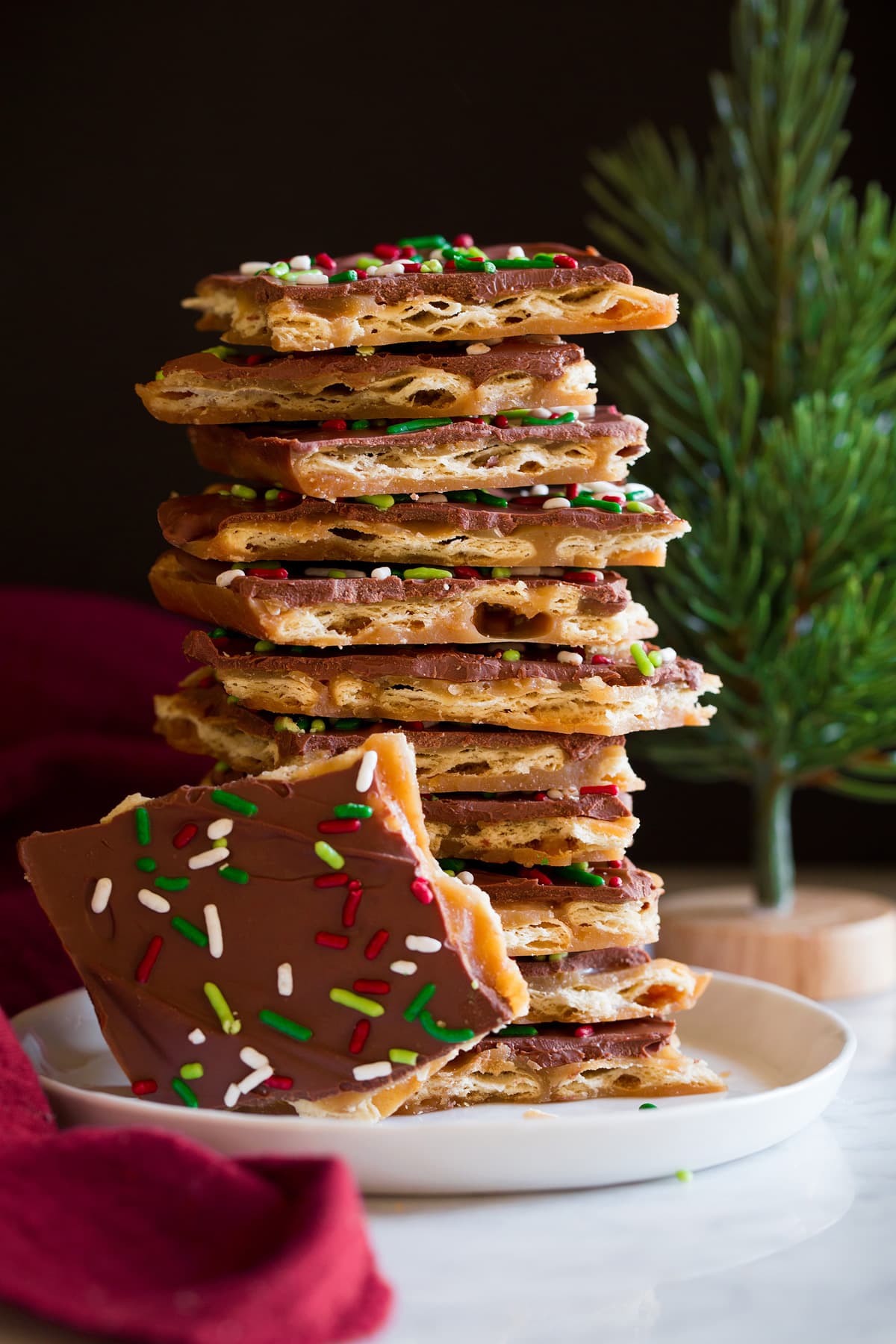 Christmas Crack Tall stack of homemade Christmas Crack on a white dessert plate.