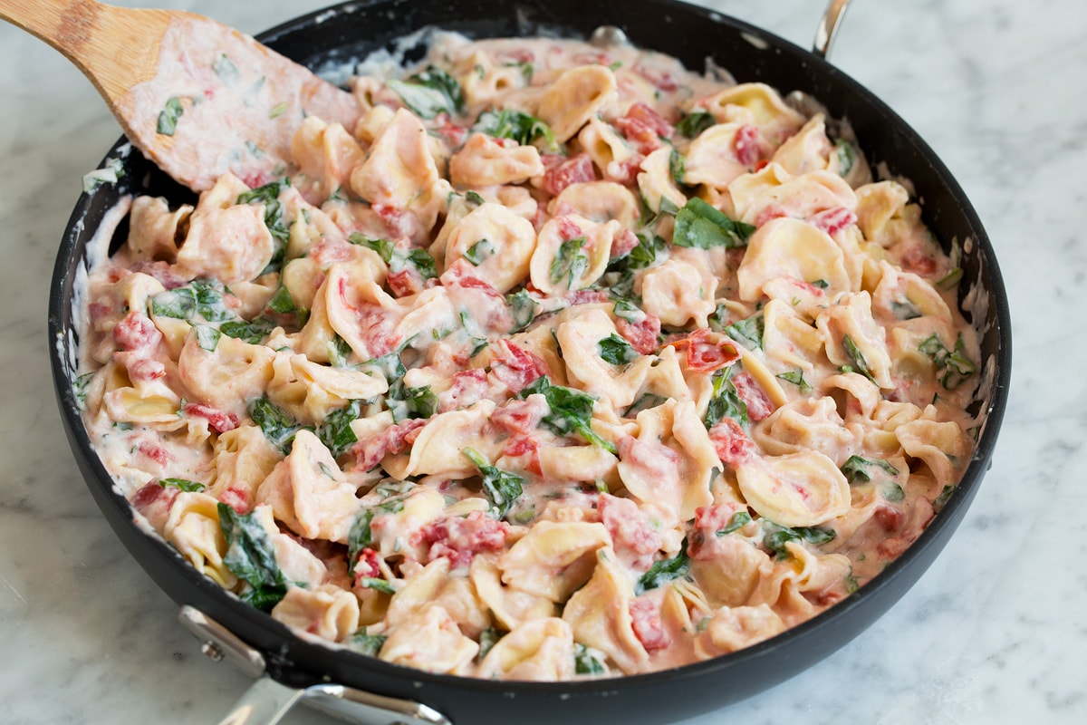 Creamy Spinach Tomato Tortellini Finished tortellini recipe in a skillet.