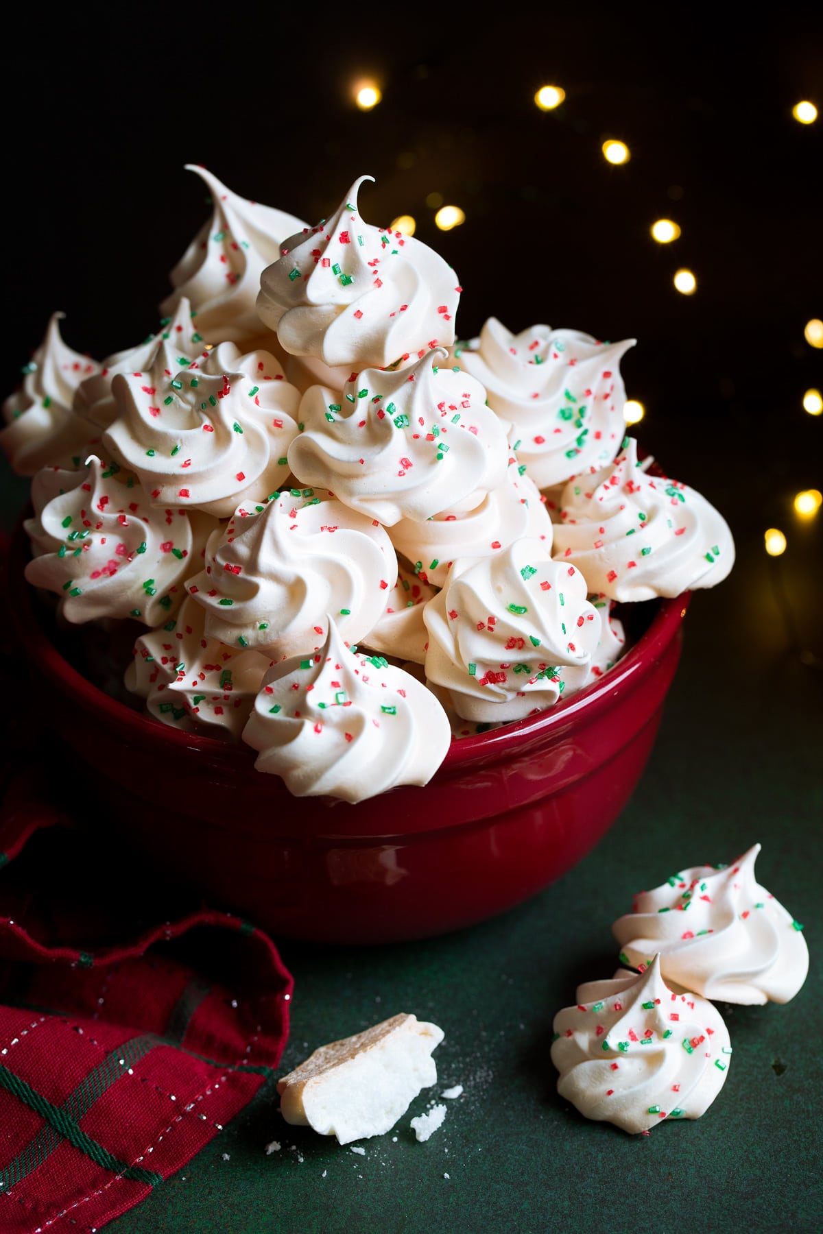 Meringue Cookies Meringue Cookies decorated with Christmas sprinkles in a red bowl.