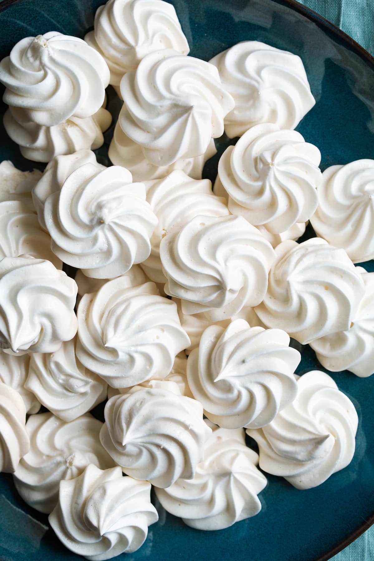 Meringue Cookies Close up image of meringue cookies on a large blue plate.