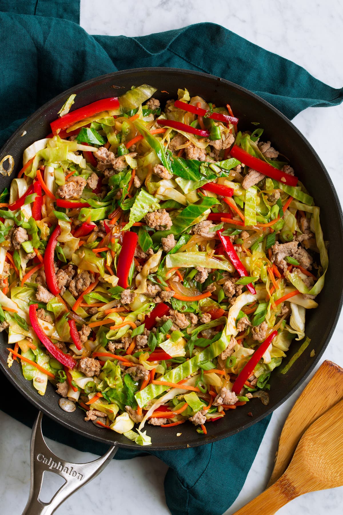 Egg Roll in a Bowl Overhead image of egg roll in a bowl in a skillet shown after completed cooking. In it you see cabbage, ground turkey, red bell pepper, and carrots.