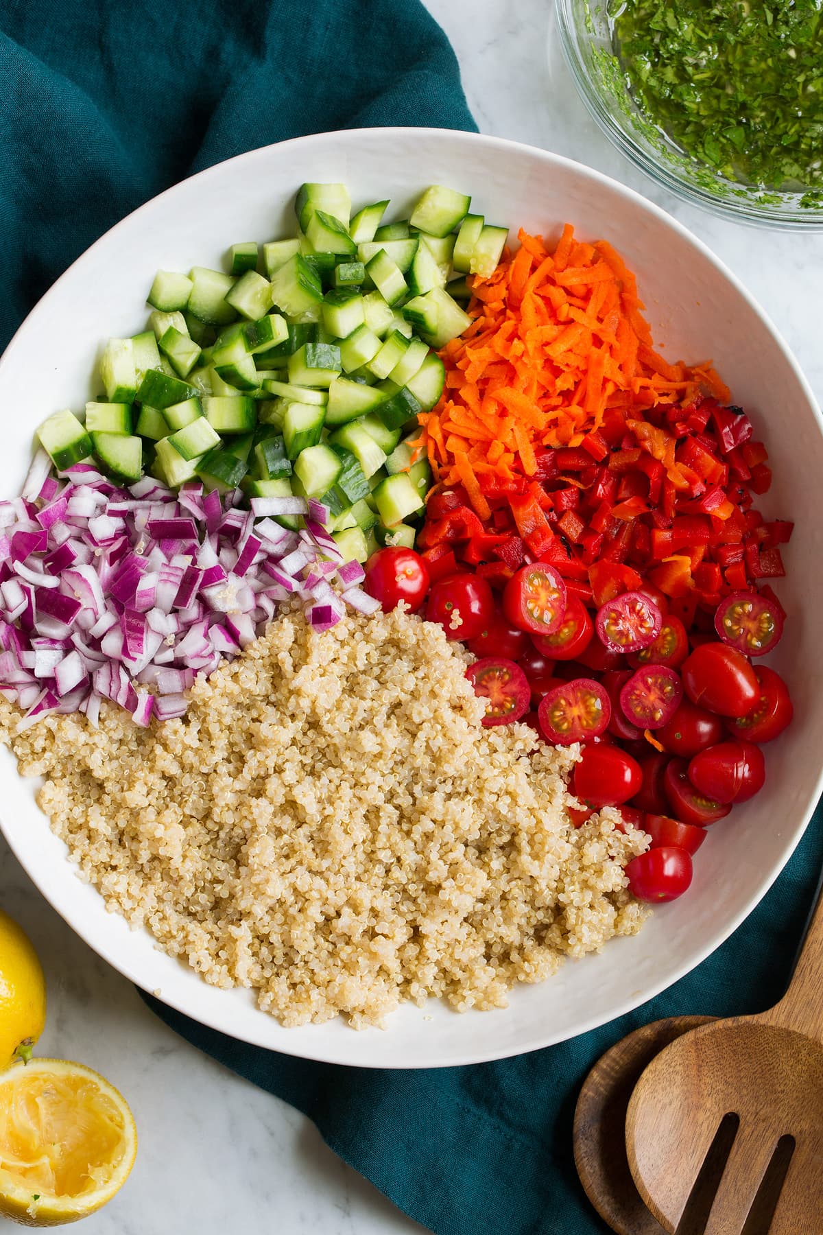 Quinoa Salad Prepare quinoa salad ingredients in a salad bowl before tossing with dressing.