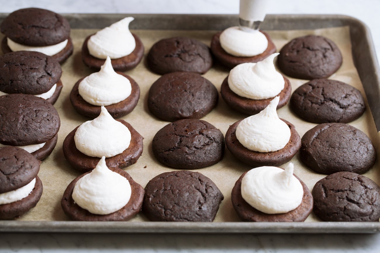 Whoopie Pies Piping marshmallow cream filling over cookies.
