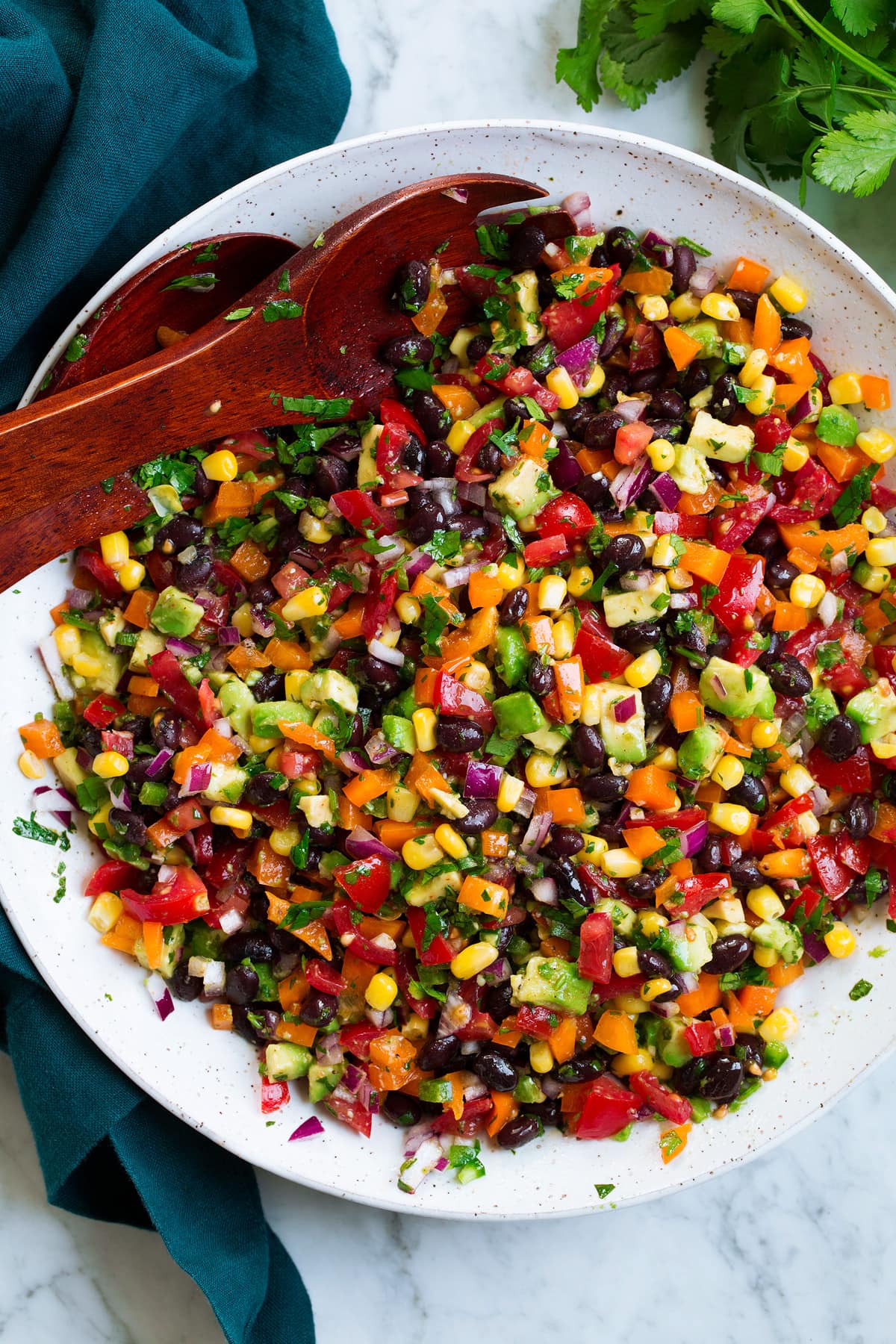 Black Bean and Corn Salad Black bean and corn salad with bell pepper, avocado, tomato and cilantro lime dressing.