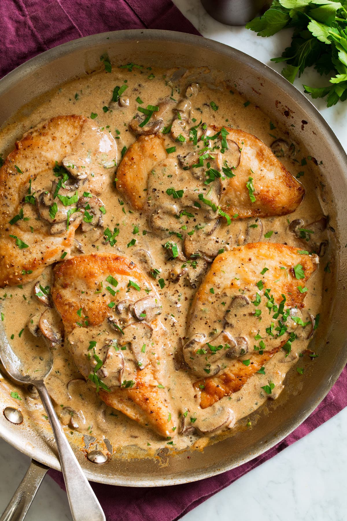 Creamy Chicken Marsala Four servings of chicken marsala in a large skillet covered with creamy chicken marsala wine and mushroom sauce.