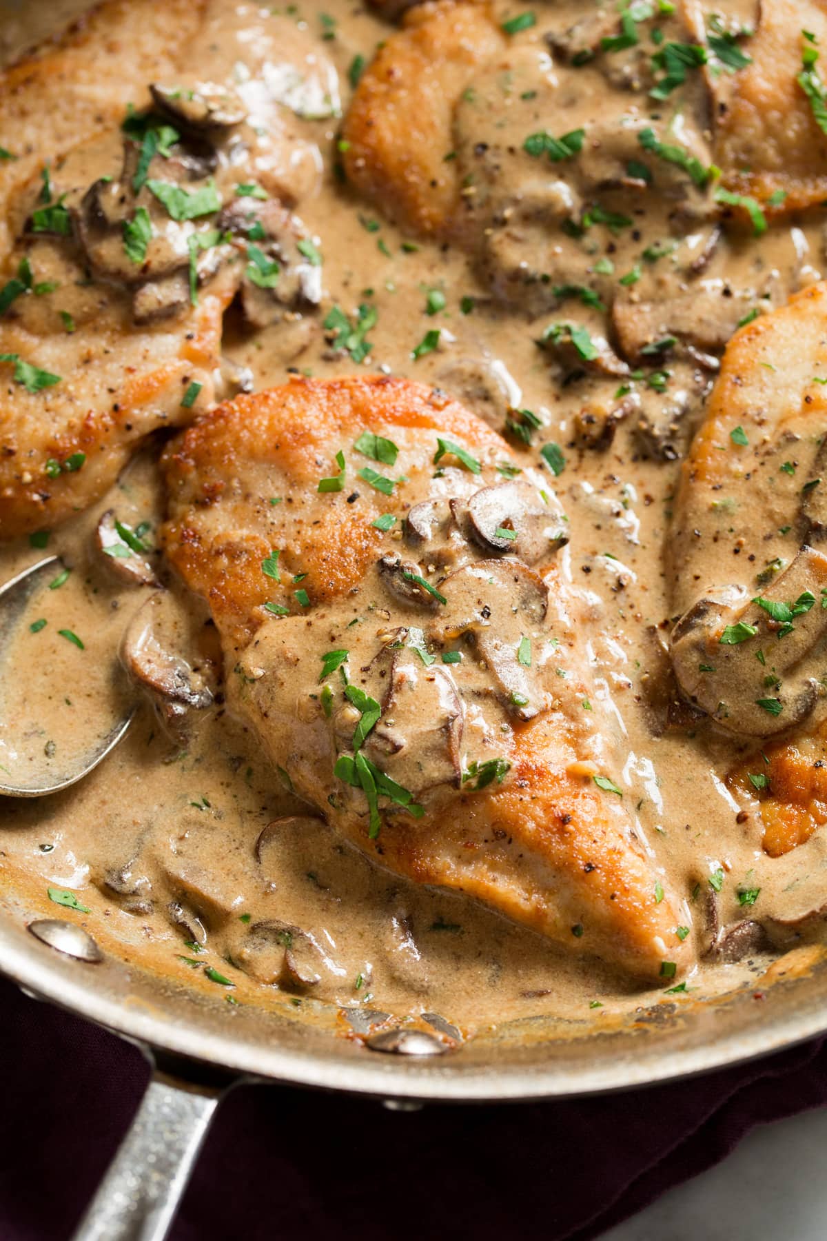 Creamy Chicken Marsala Homemade chicken marsala in a large aluminum skillet.