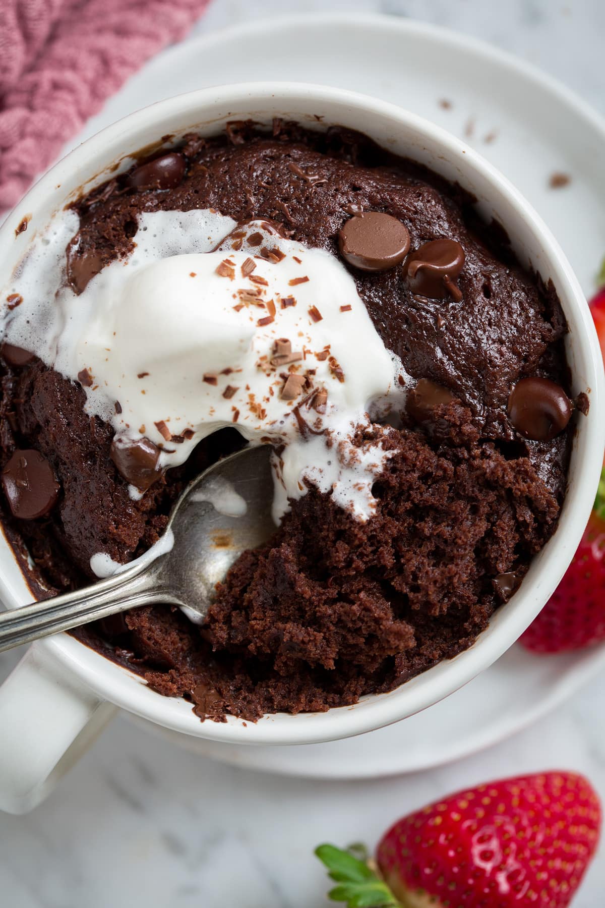Chocolate Mug Cake Close up image of chocolate mug cake being scooped into with a spoon.