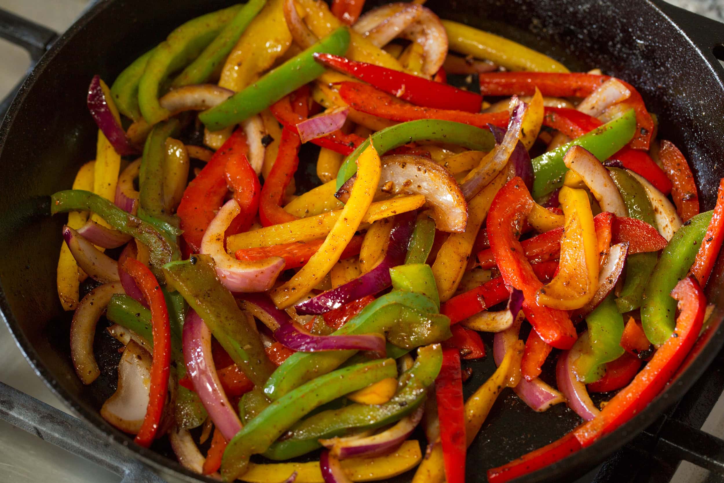 Chicken Fajitas Cooked bell peppers and onions in skillet.